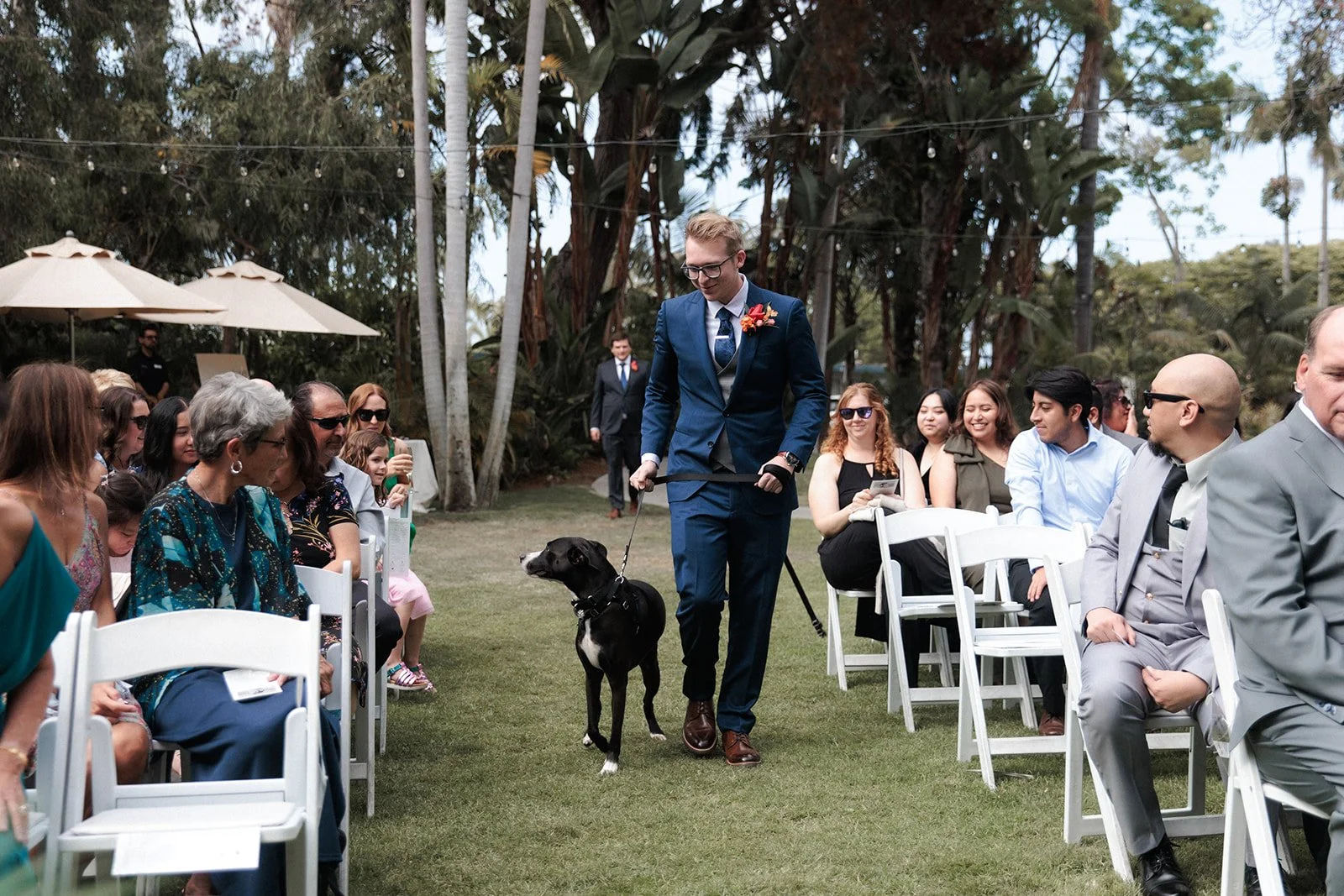 Groom walks his down down isle at wedding ceremony at Paradise Point, San Diego.