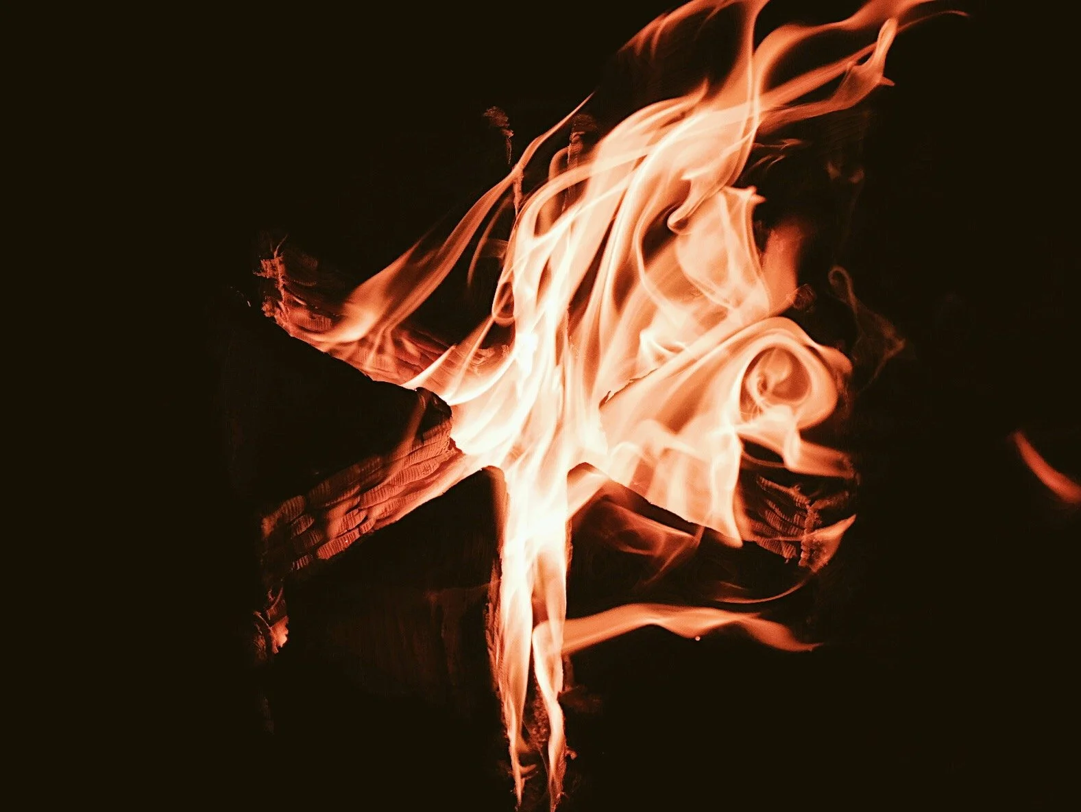 Fire flames burning against a dark background.