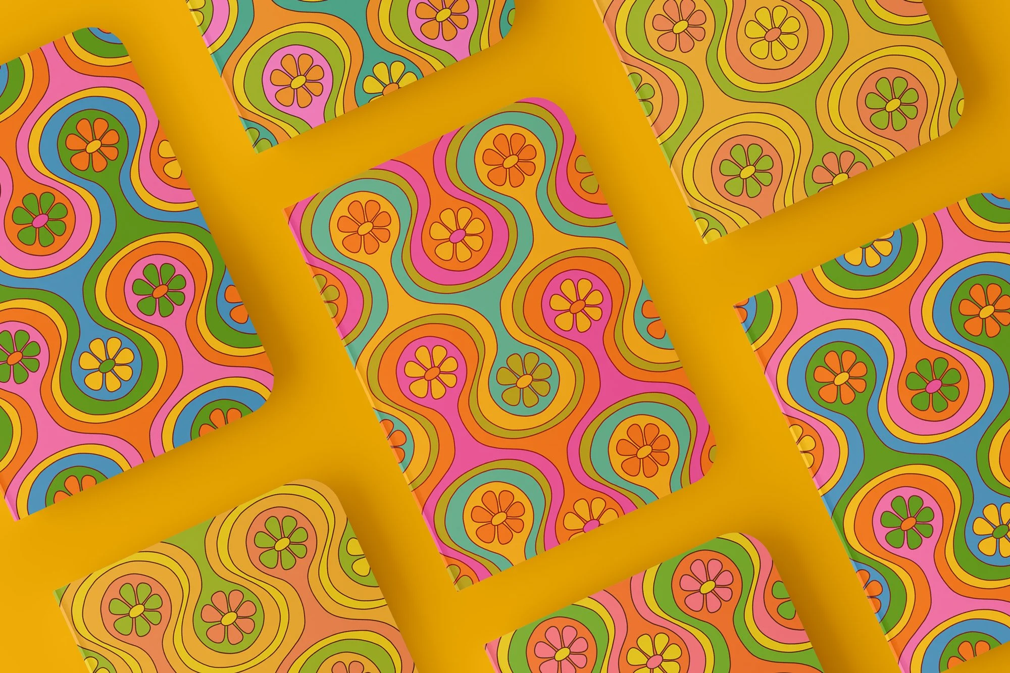Flat lay of journals each with a colorful, groovy pattern with flowers and wavy lines in pink, orange, yellow, green, and blue.