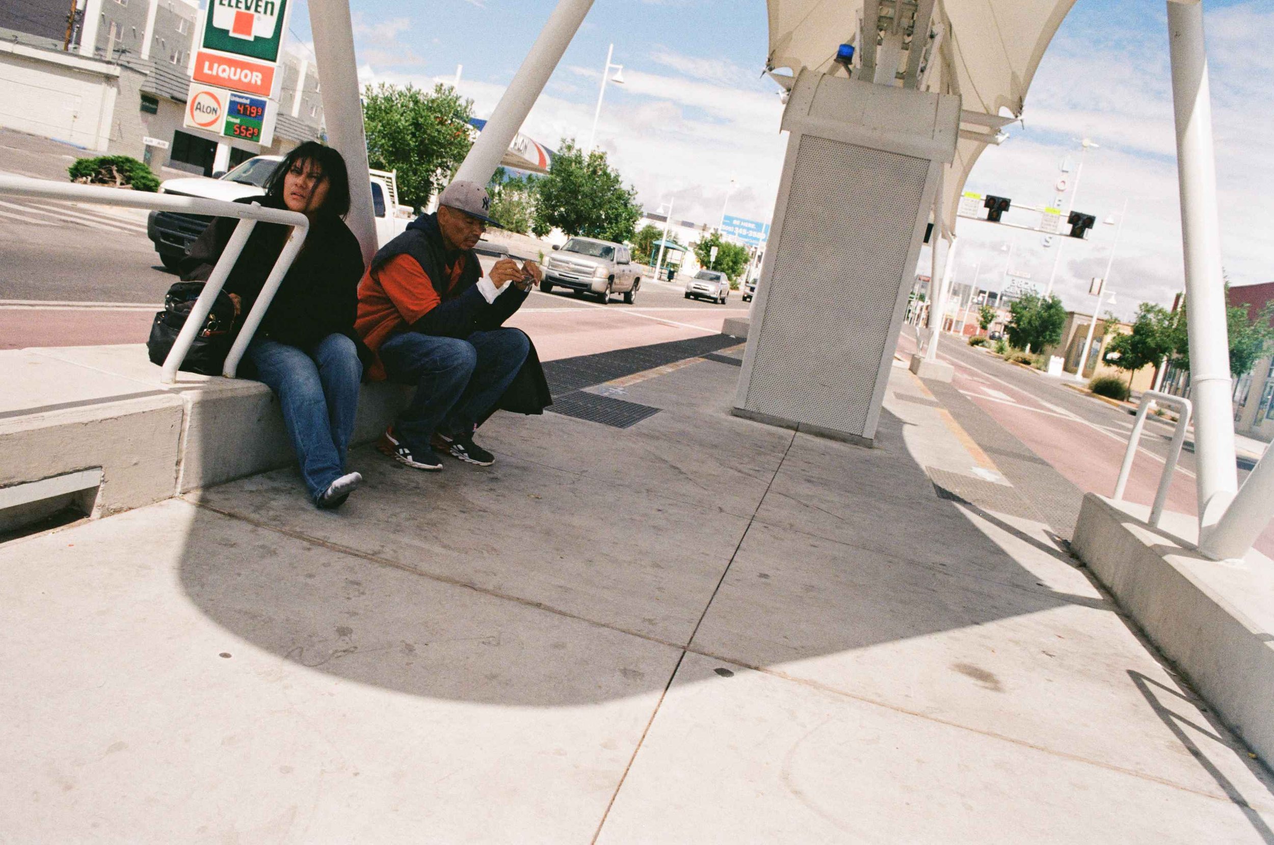 (woman and man waiting at a bus stop), Central Ave. Albuquerque, 2022