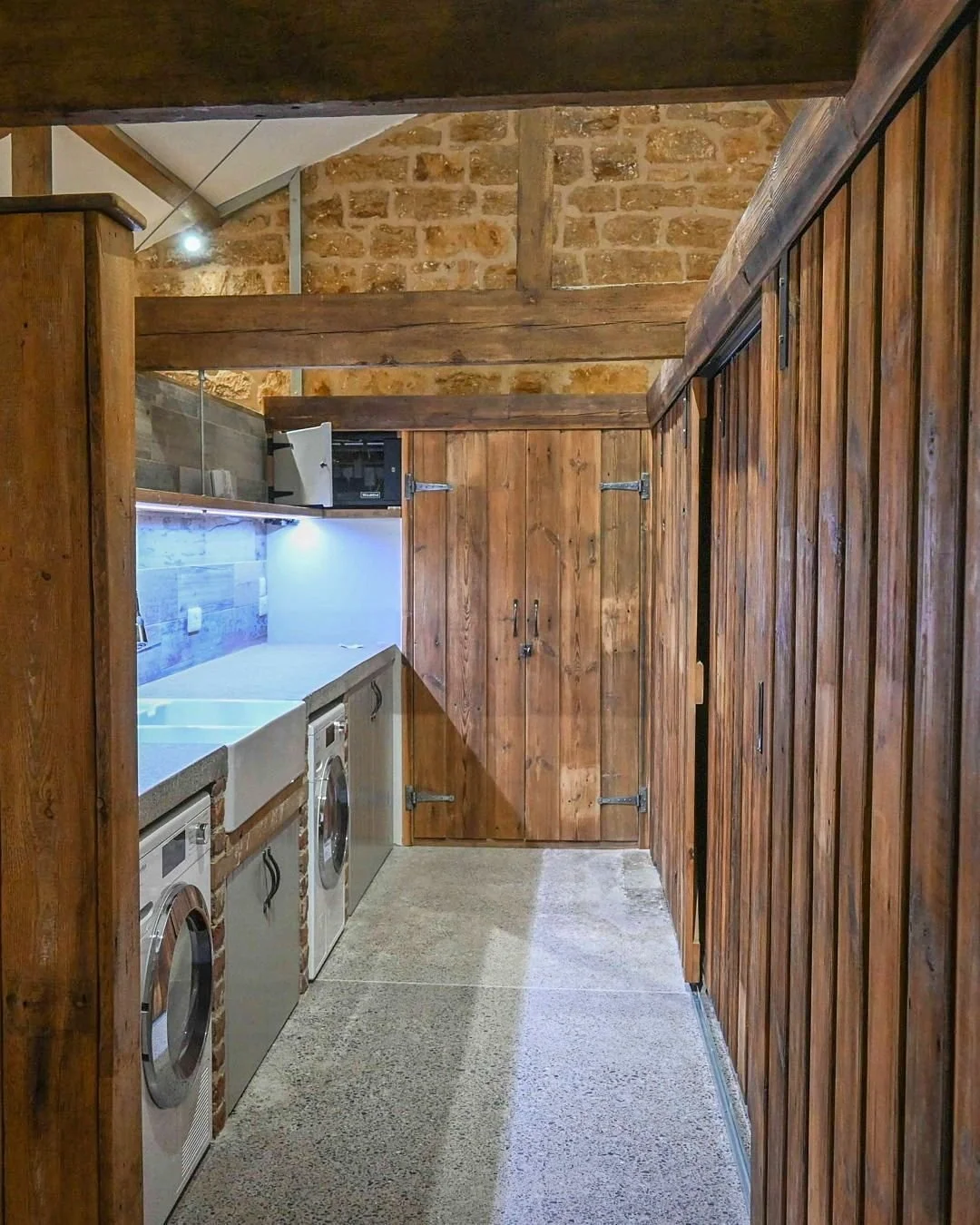 Reclaimed pine sliding doors in a tucked away utility room at a barn conversion we worked on a few years ago. Particularly loved the brick pillars framing a Belfast sink and completed with a polished concrete work bench.