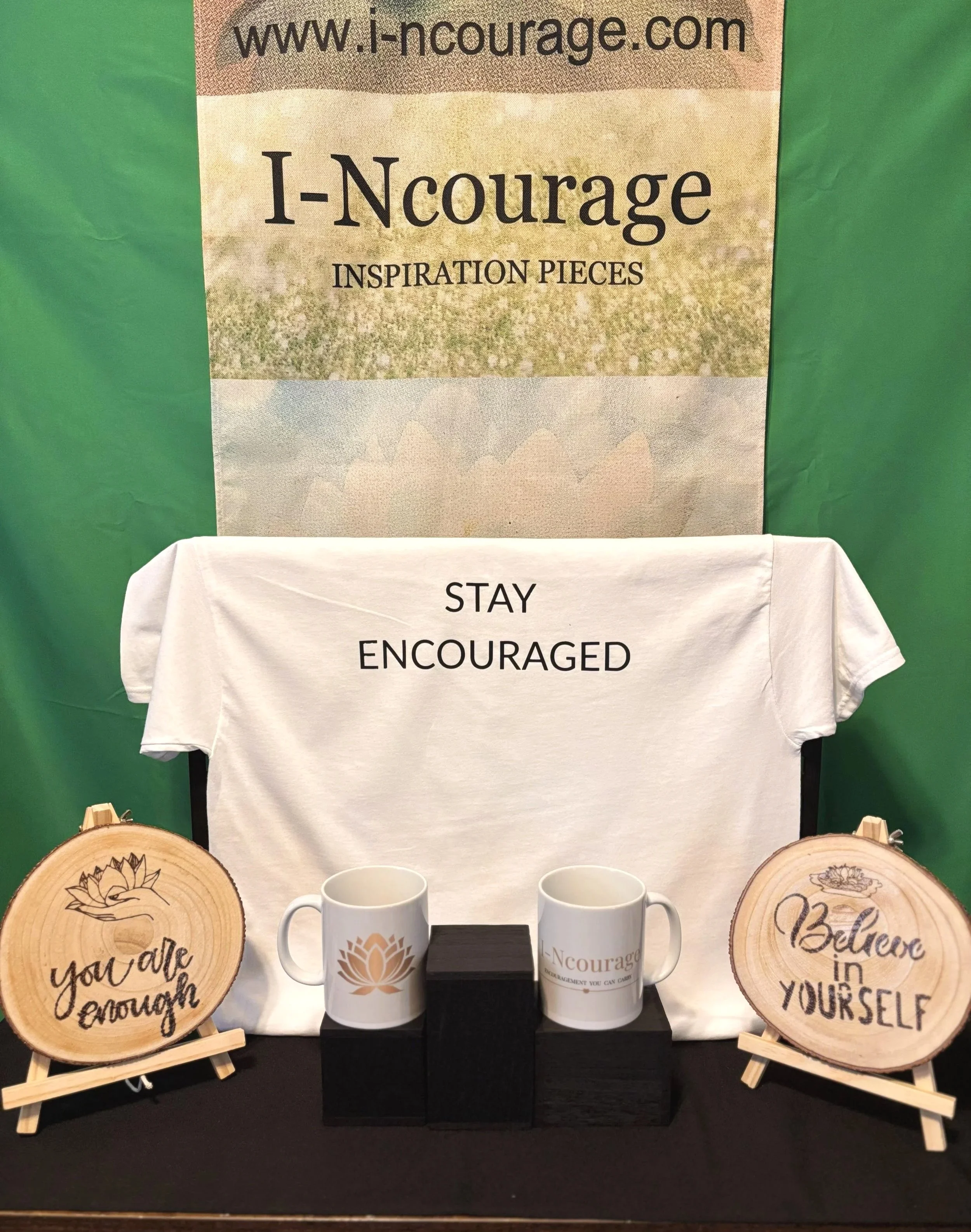 "Stay Encouraged gift bundle featuring affirmation wood slices, motivational apparel, and lotus mugs by I-Ncourage."