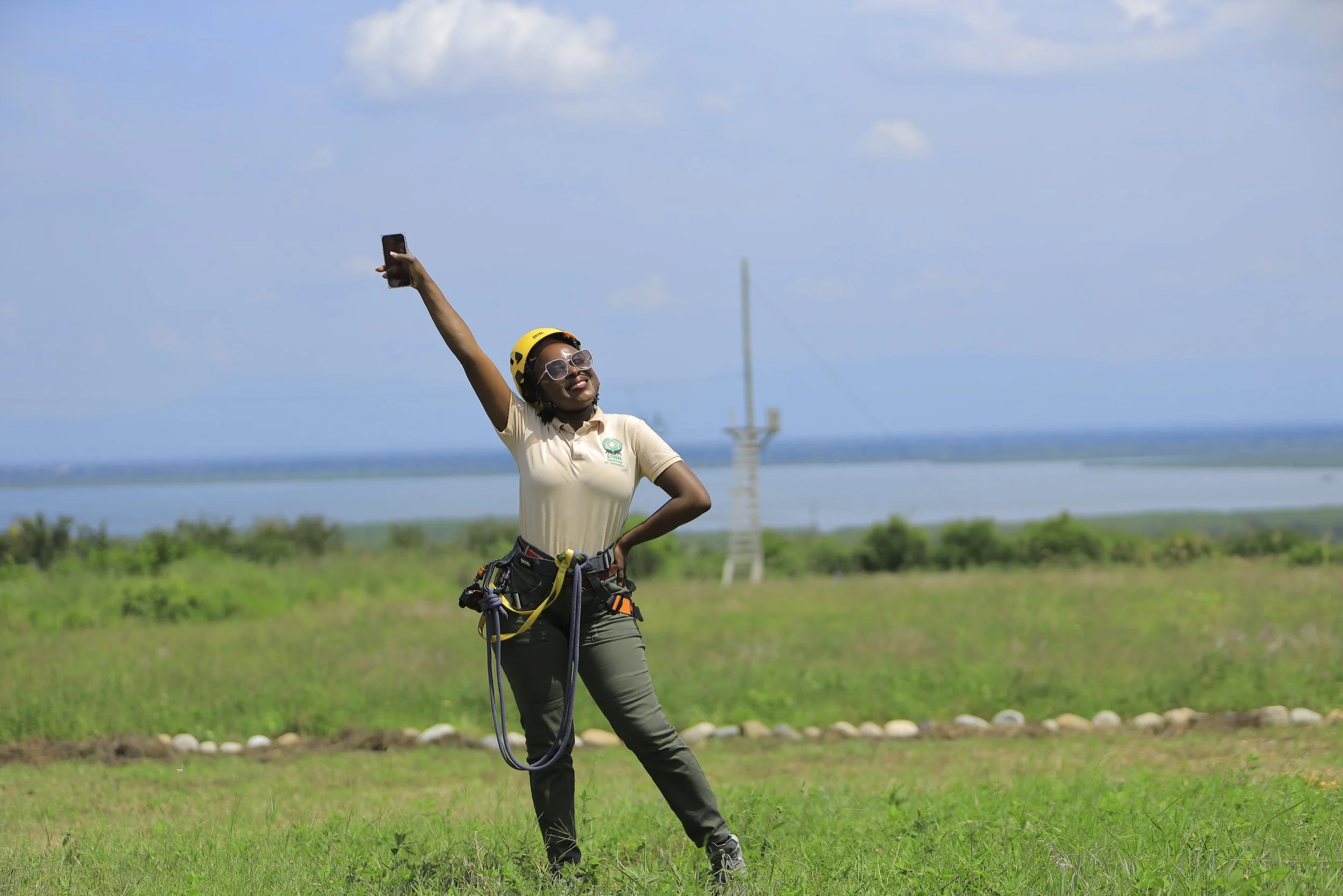 Smiling woman in climbing harness and helmet