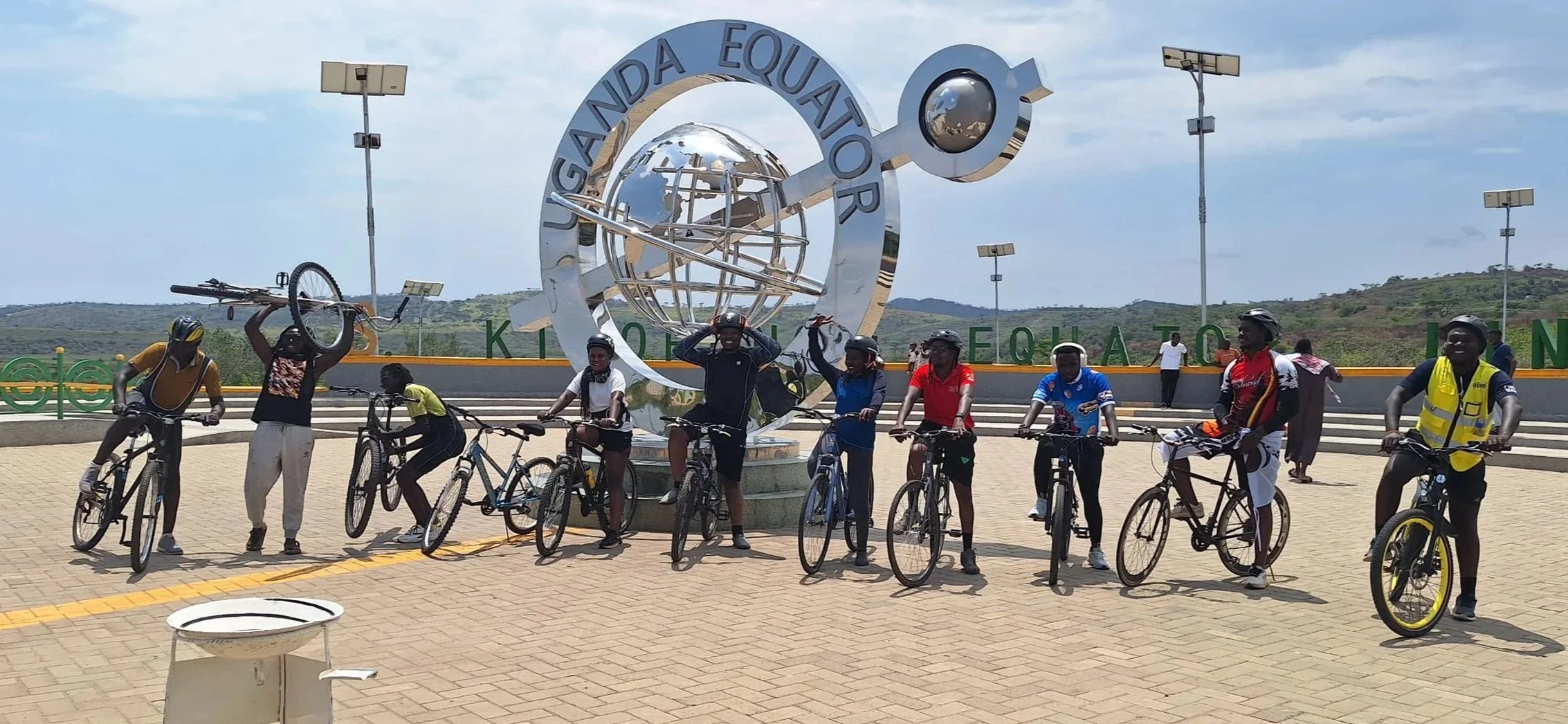 Group of cyclists at the equator monument