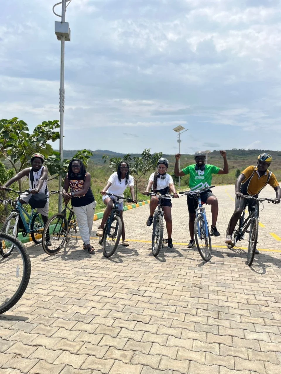 Smiling group of cyclists on a paved brick path