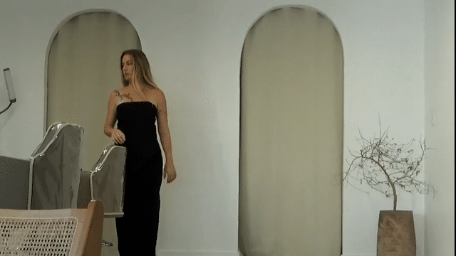 Woman in black with tousled blonde waves, hair by Austin hairstylist Mikki Auld