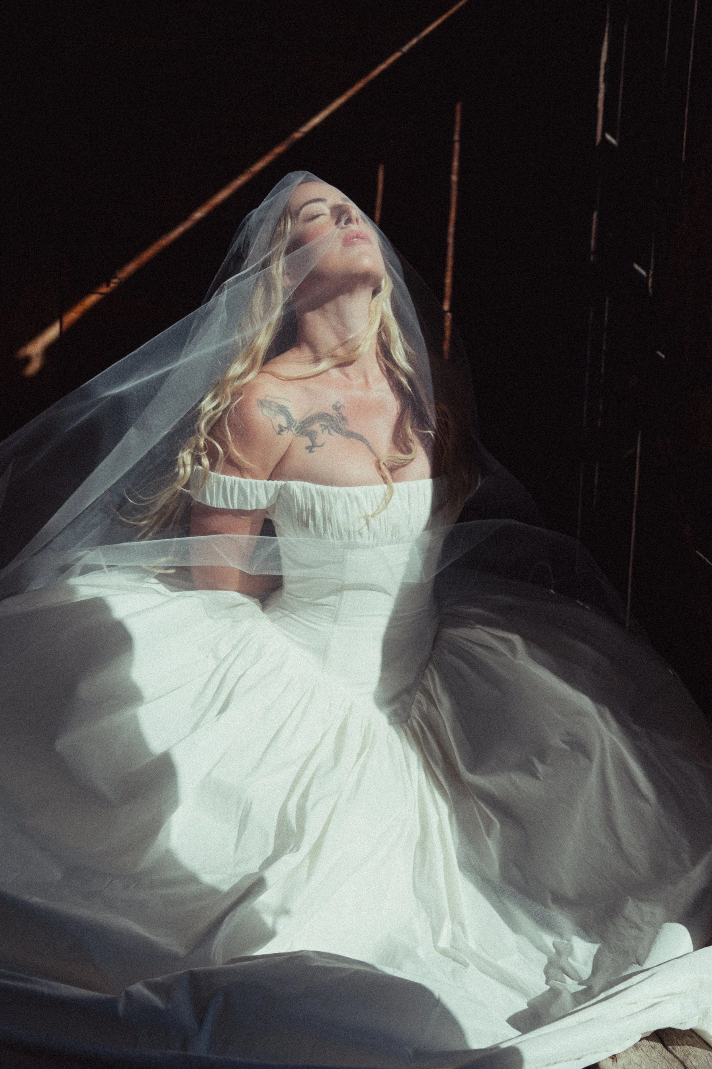 Bride with tousled lived-in blonde hair under a sheer veil, bridal hair by Austin wedding hairstylist Mikki Auld