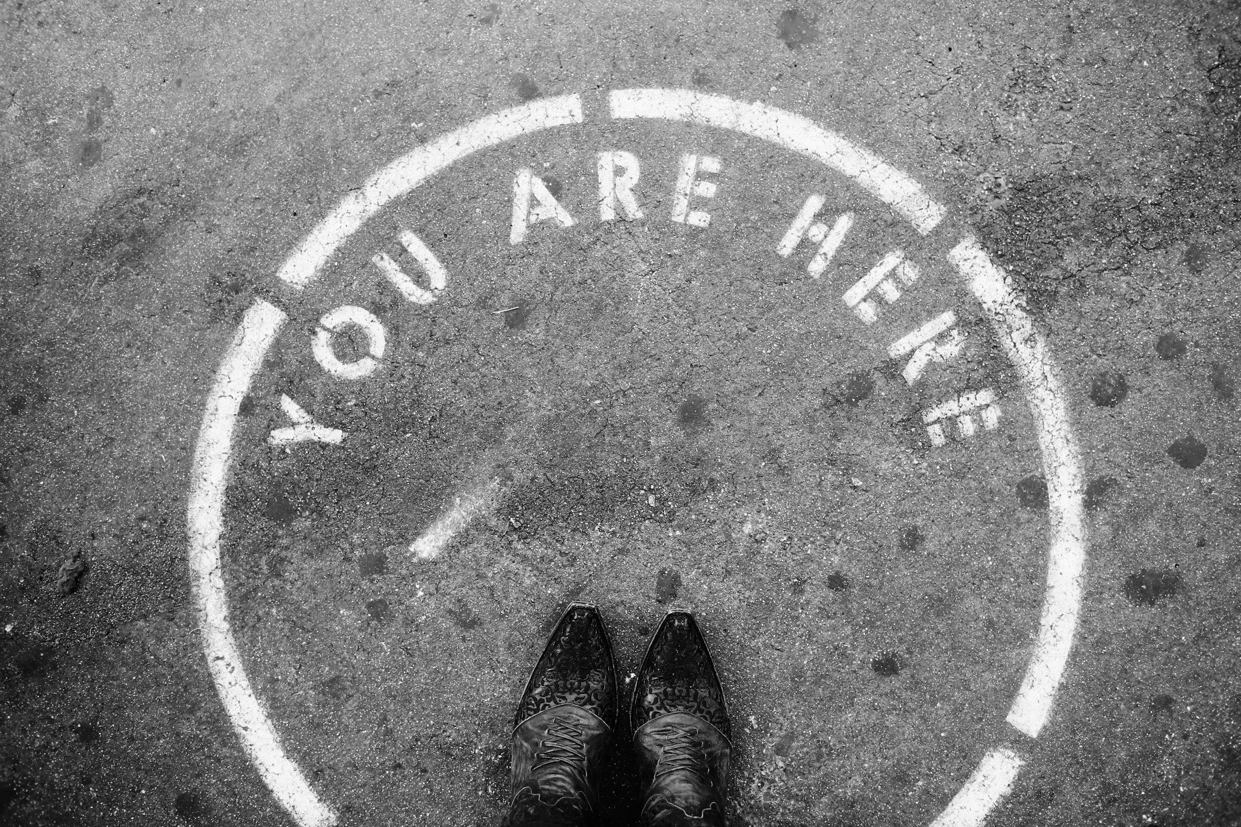 Feet stand in a circle that reads, "You are Here," pointing to the increase in self-awareness and acceptance.