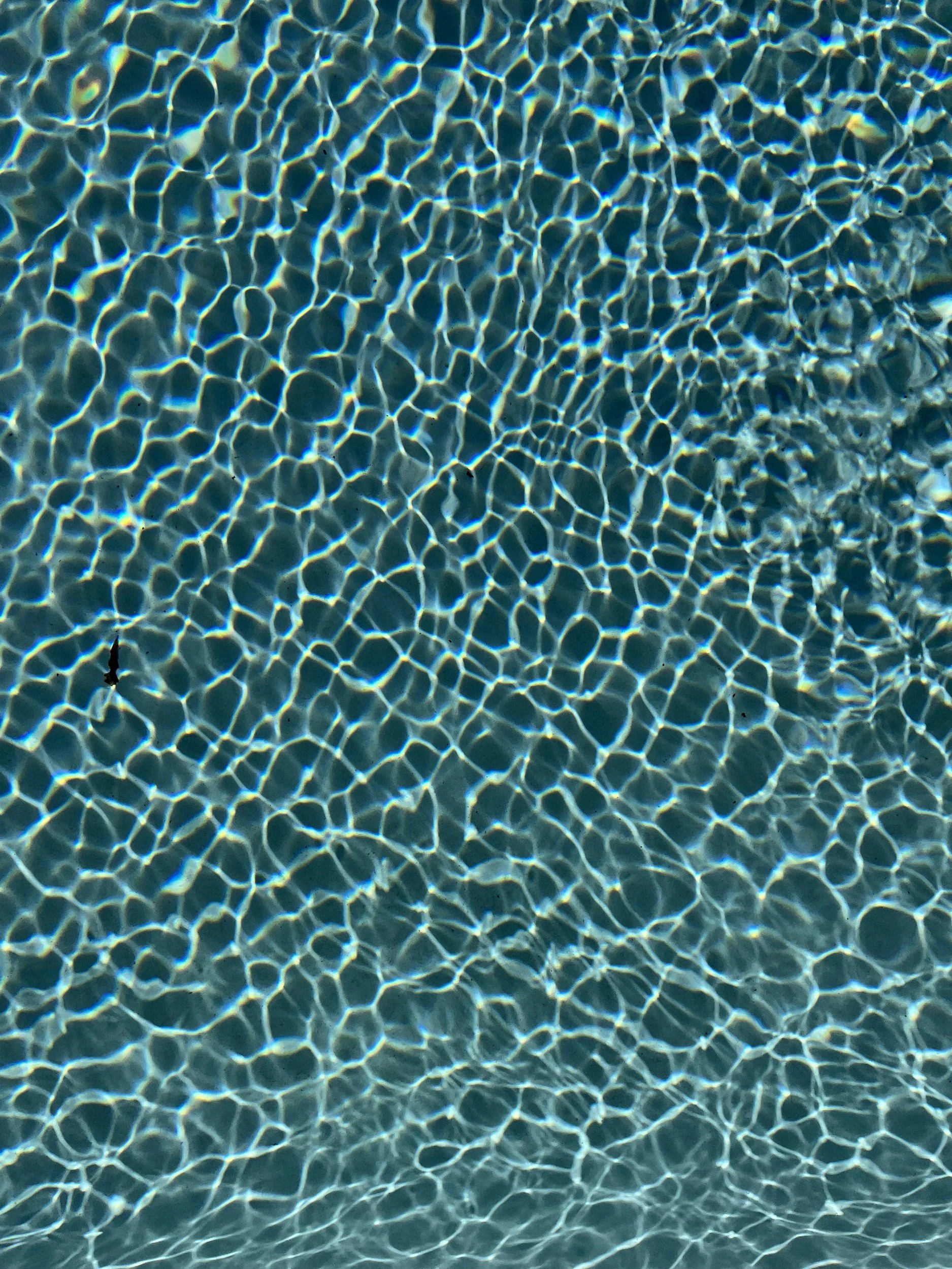 Ripples of sunlight through pool water, showcasing the depth of the subconscious.