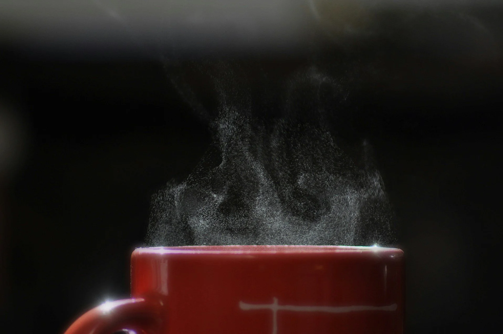 Steam rises from a coffee cup, symbolizing the importance of air to the New Moon's chart.