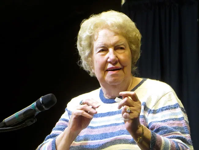 Dolores Cannon speaking at a microphone