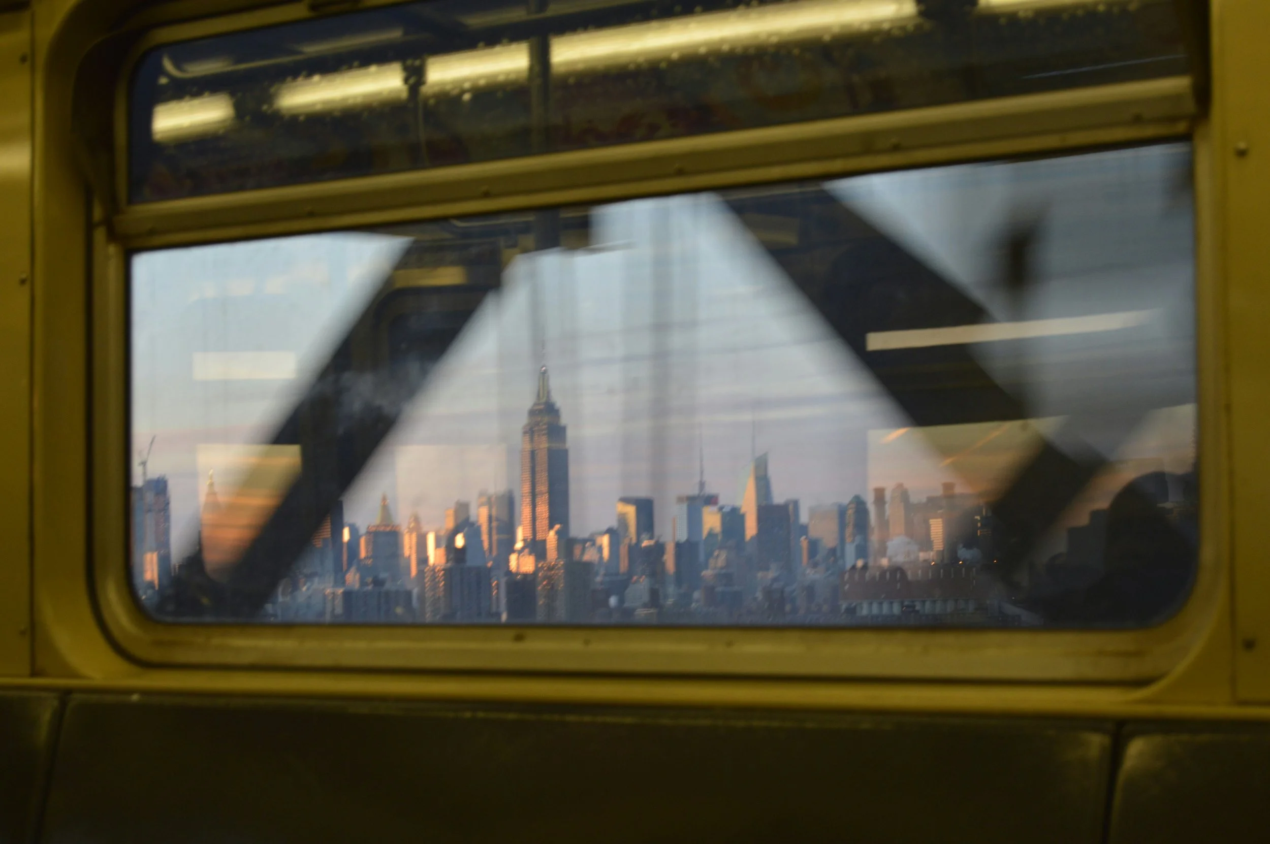 Photo of Manhattan taken rom inside moving subway train.