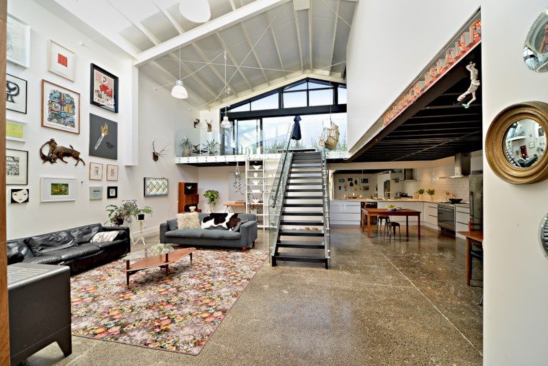 Modern home interior with staircase and mezzanine floor.