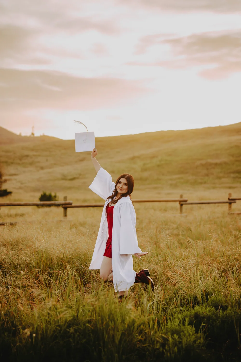  cap and gown senior pictures in a field 