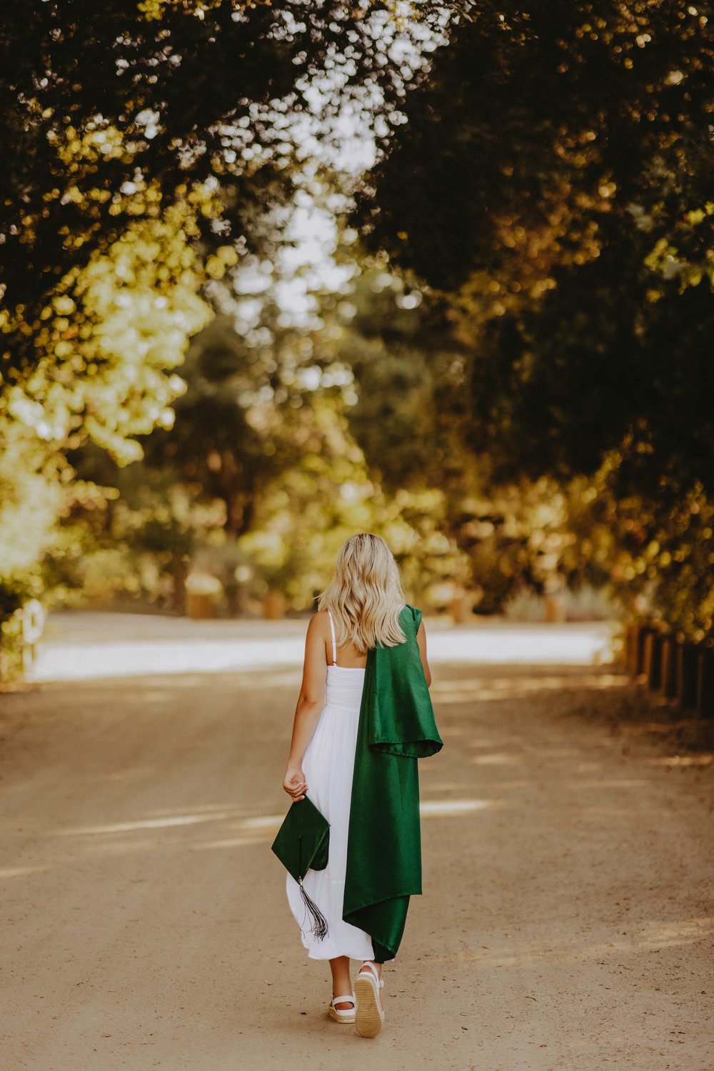  senior photo poses walking away cap and gown 