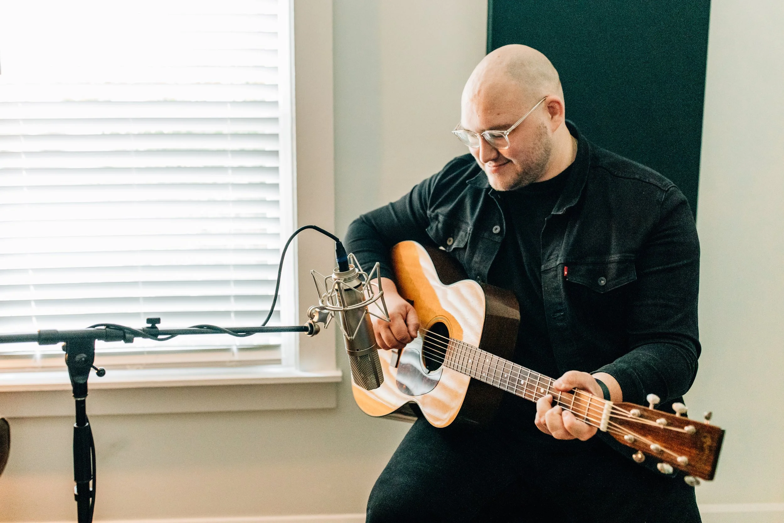 Nashville producer Josh Dunn tracking acoustic guitar in front of condenser microphone