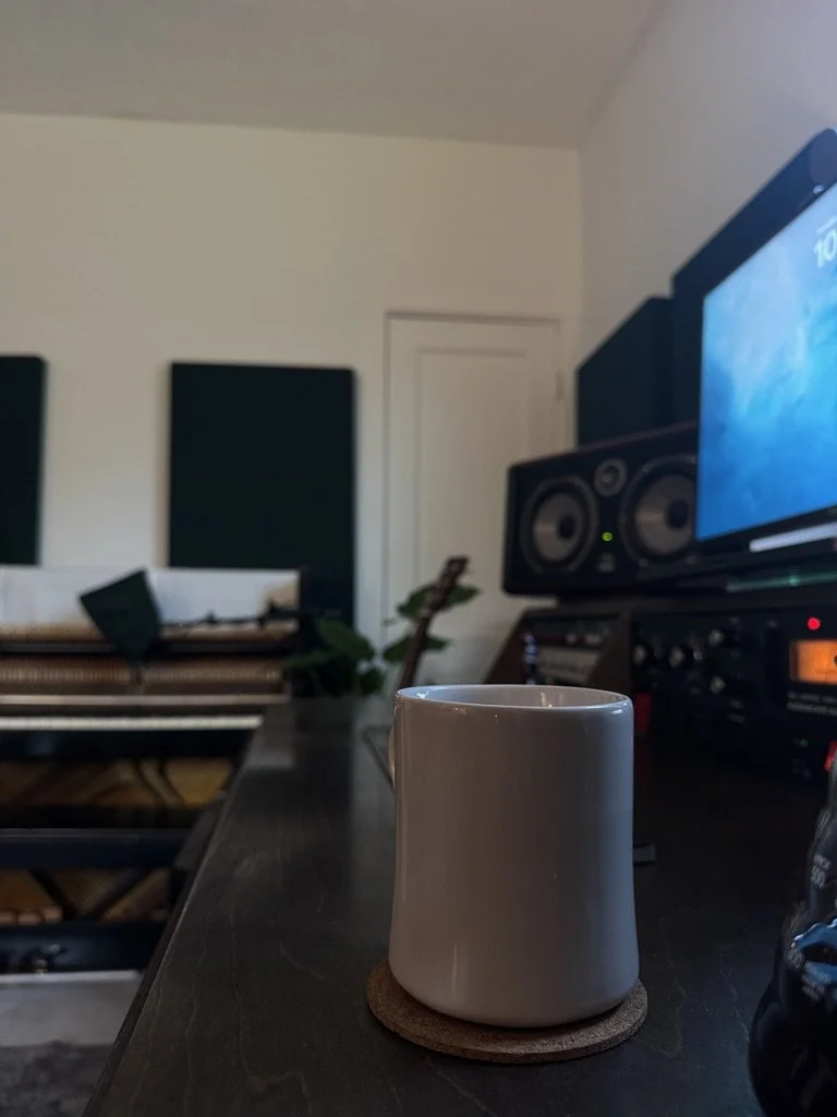 Nashville recording studio with Focal studio monitors, vintage upright piano, and acoustic treatment