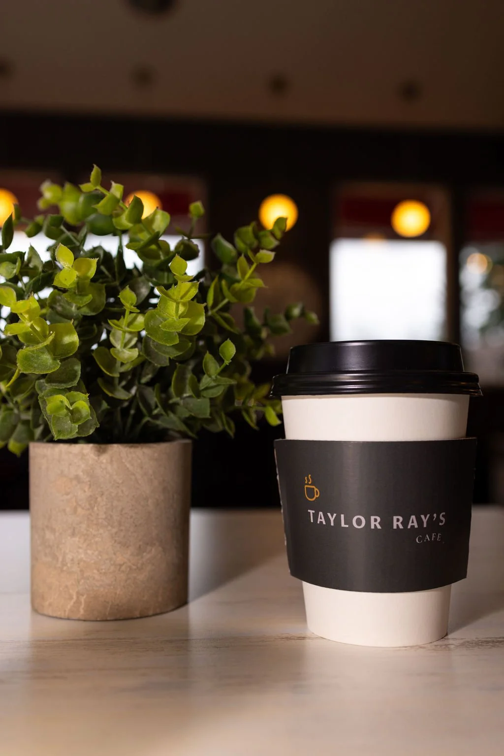 Coffee Drink Next to Plant