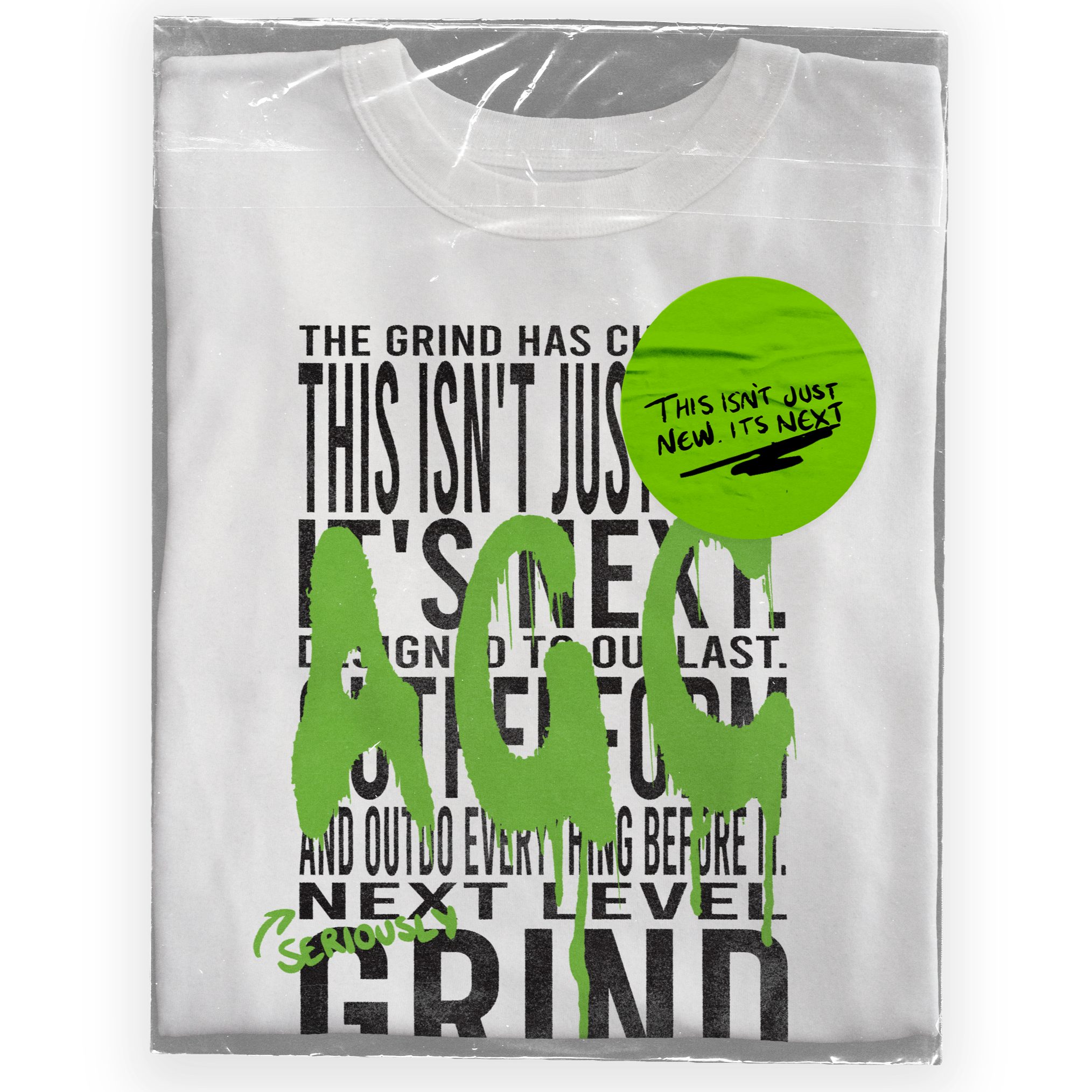 Graphic T-shirt design with large black text and green graffiti-style words, featuring a green sticker with handwritten text. The shirt has a motivational message about dedication and grind, with additional messaging on the sticker about an upcoming release.