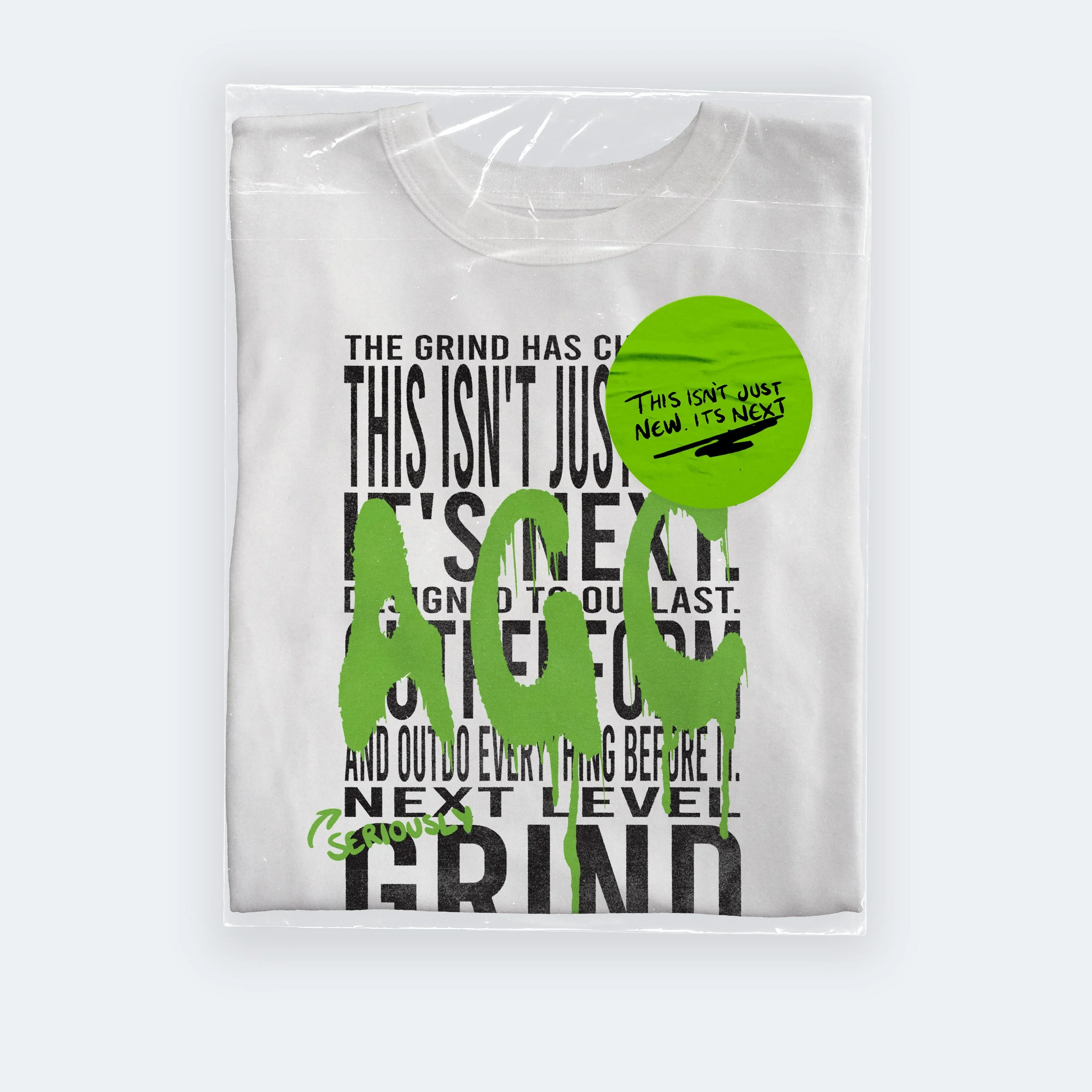 White t-shirt in clear plastic packaging with black text and green graffiti-style overlay saying "Ape". Green sticker on package says "This isn't just new. It's next" with ‘‘Seriously’’ written in green.