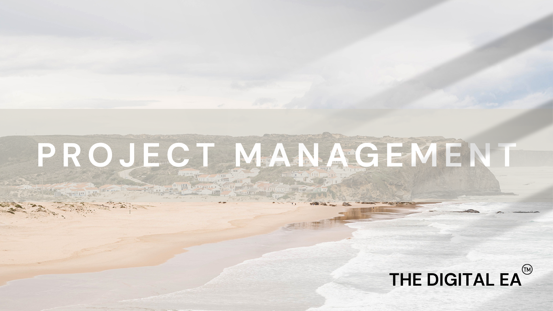 Jarrah Wallace - Kajabi Systems & Automations Partner.  Beach scene with waves, sand, and a coastal hillside with houses under a cloudy sky, overlaid with the text 'Project Management' and 'The Digital EA'.