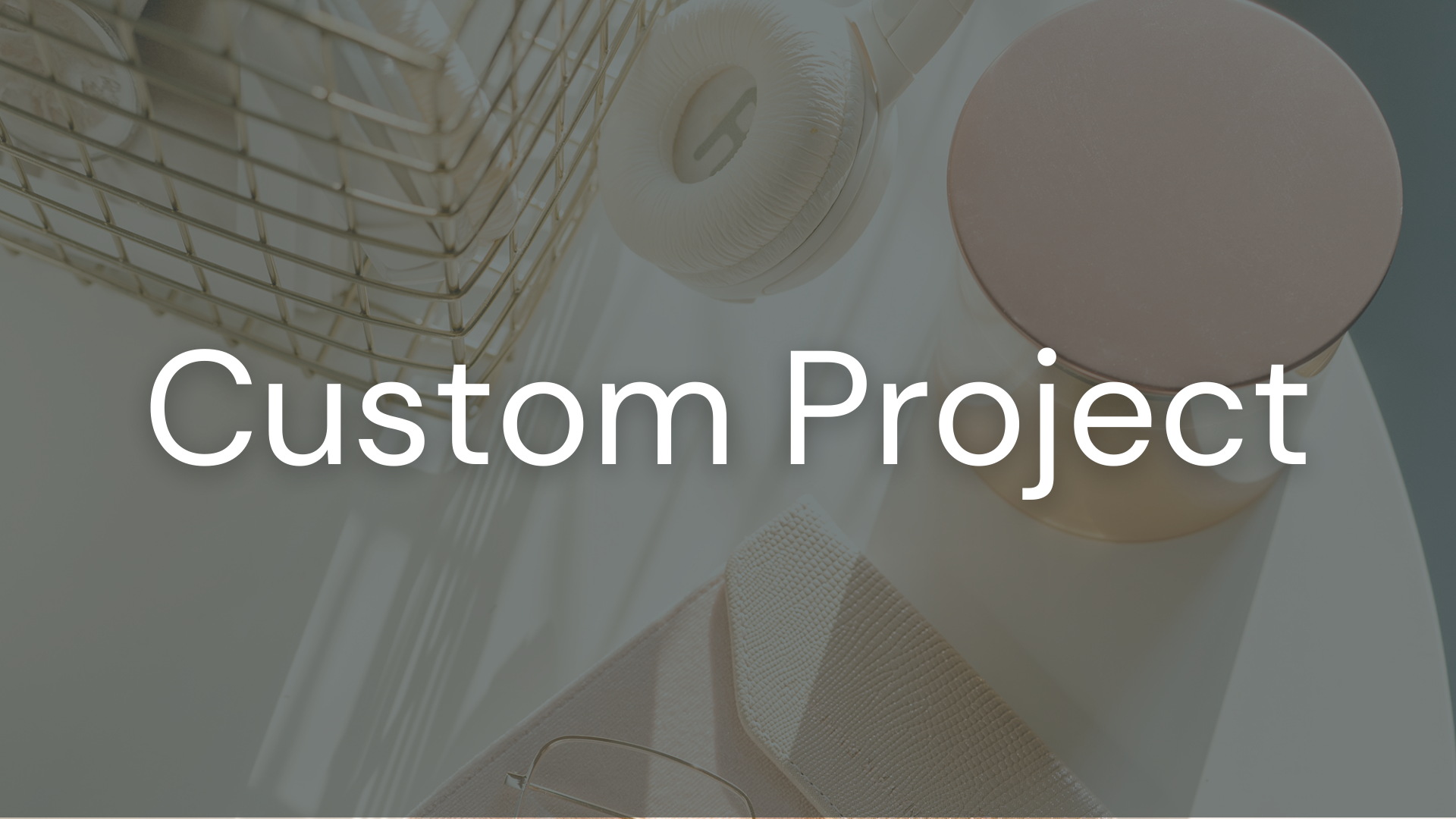 Jarrah Wallace - Kajabi Systems & Automations PartnerA top view of a bathroom sink area with a metal wire basket, cream-colored headphones, a pink container, a beige textured object, and a light-colored towel, overlaid with the text "Custom Project".