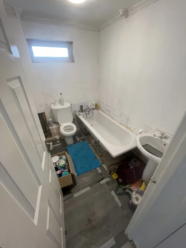 Before renovation, bath-to-shower Washington project