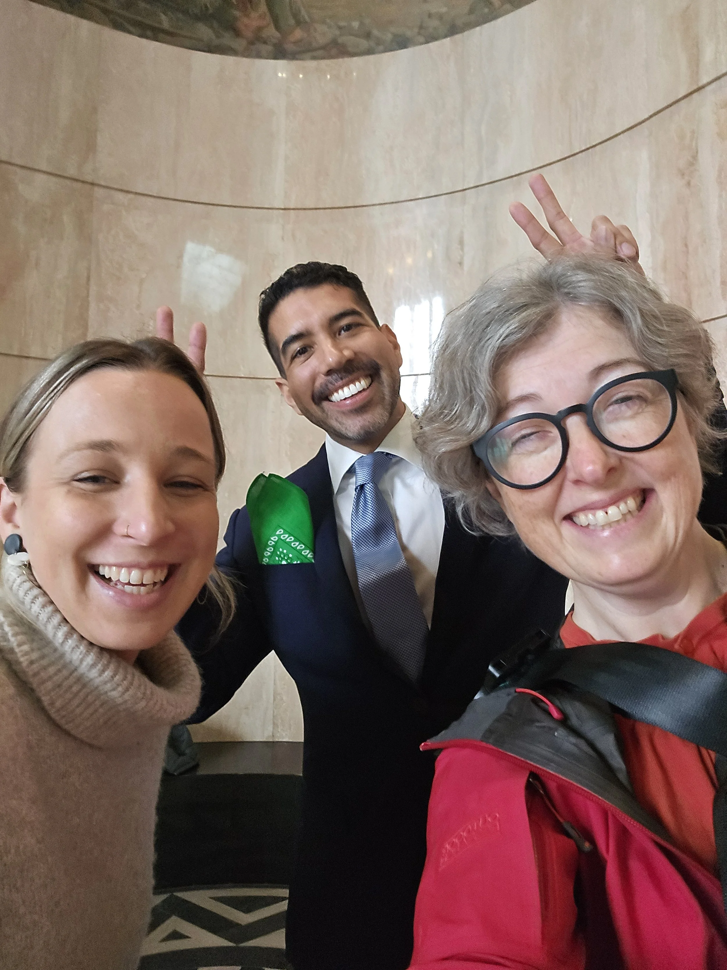 Photo of Anna Kemper, Sam Diaz, and Steph in the rotunda of the Oregon state capital.