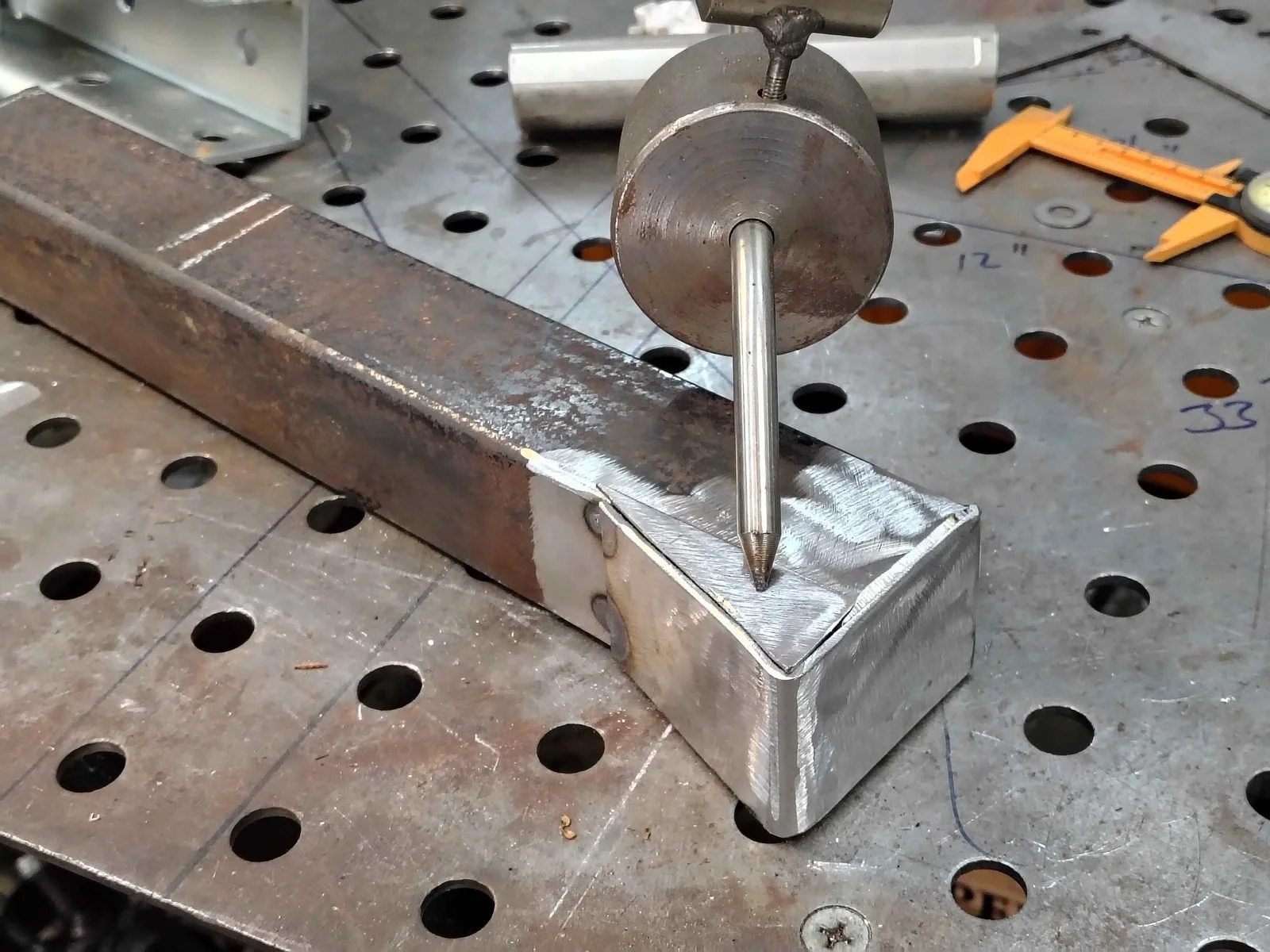 Bent plate and cut side plates forming a tapered 2x3 to 2x2 steel tube transition, laid out with a scriber by PIE Weld & Machine, serving Maryland