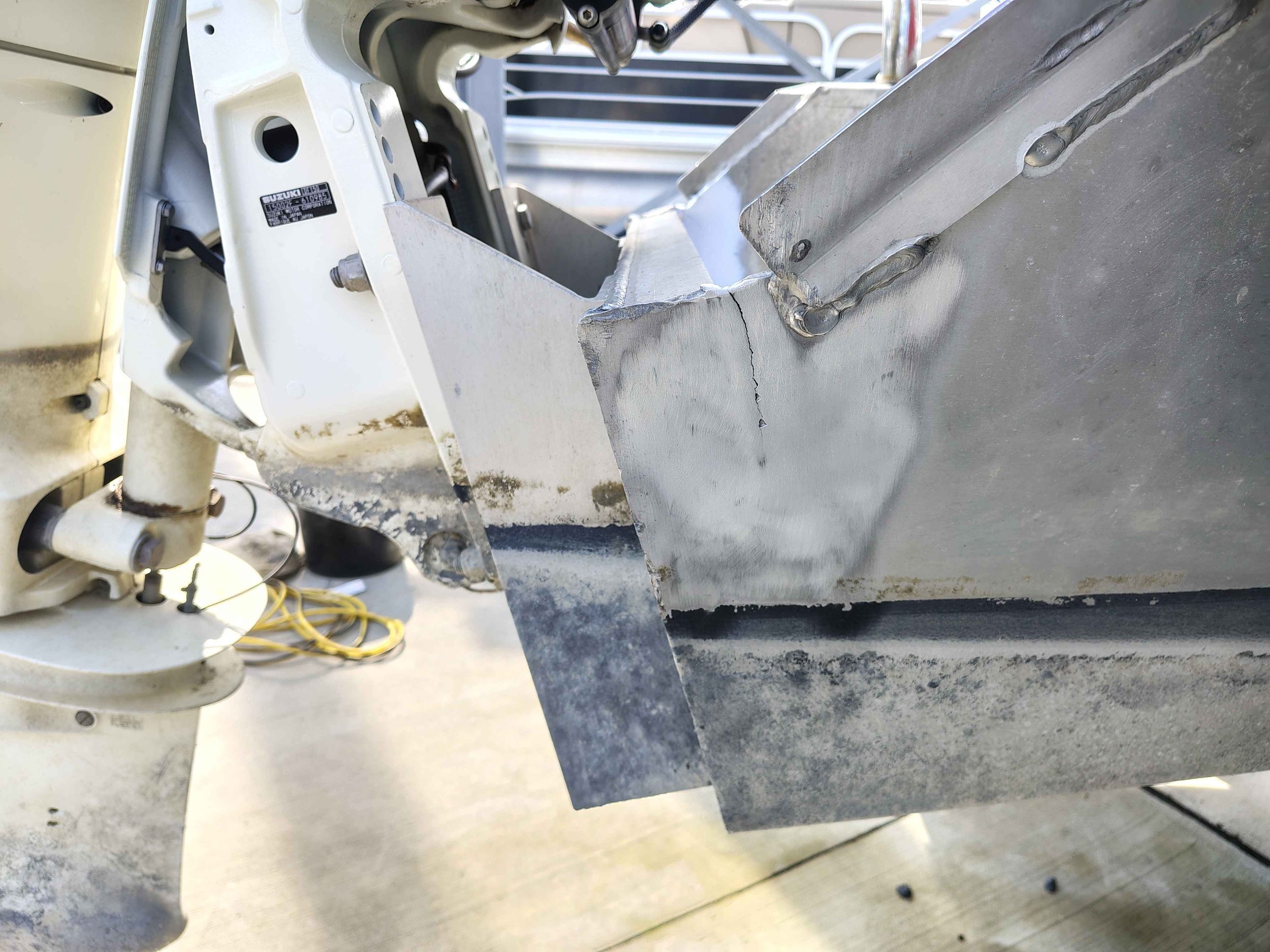Aluminum boat transom corner crack before mobile marine welding repair in Rehoboth Beach