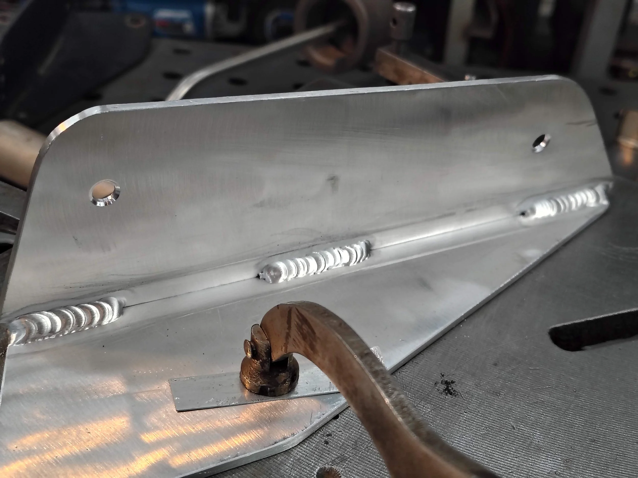 Custom fabricated aluminum airfoil slat bracket with precision TIG welds. Hand fabricated at PIE LLC Weld and Machine, Warwick MD Cecil County.