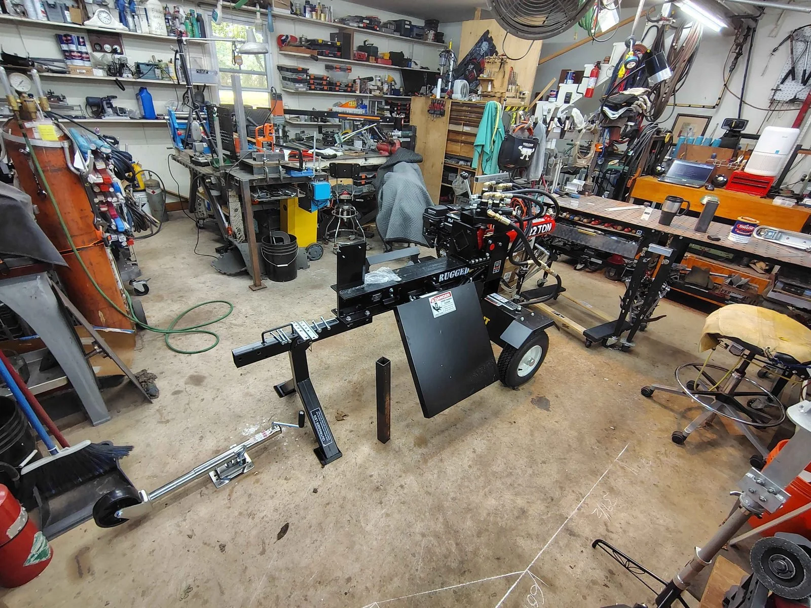 Log splitter in the PIE Weld & Machine welding and fabrication shop ready for a custom tongue extension, serving Delaware