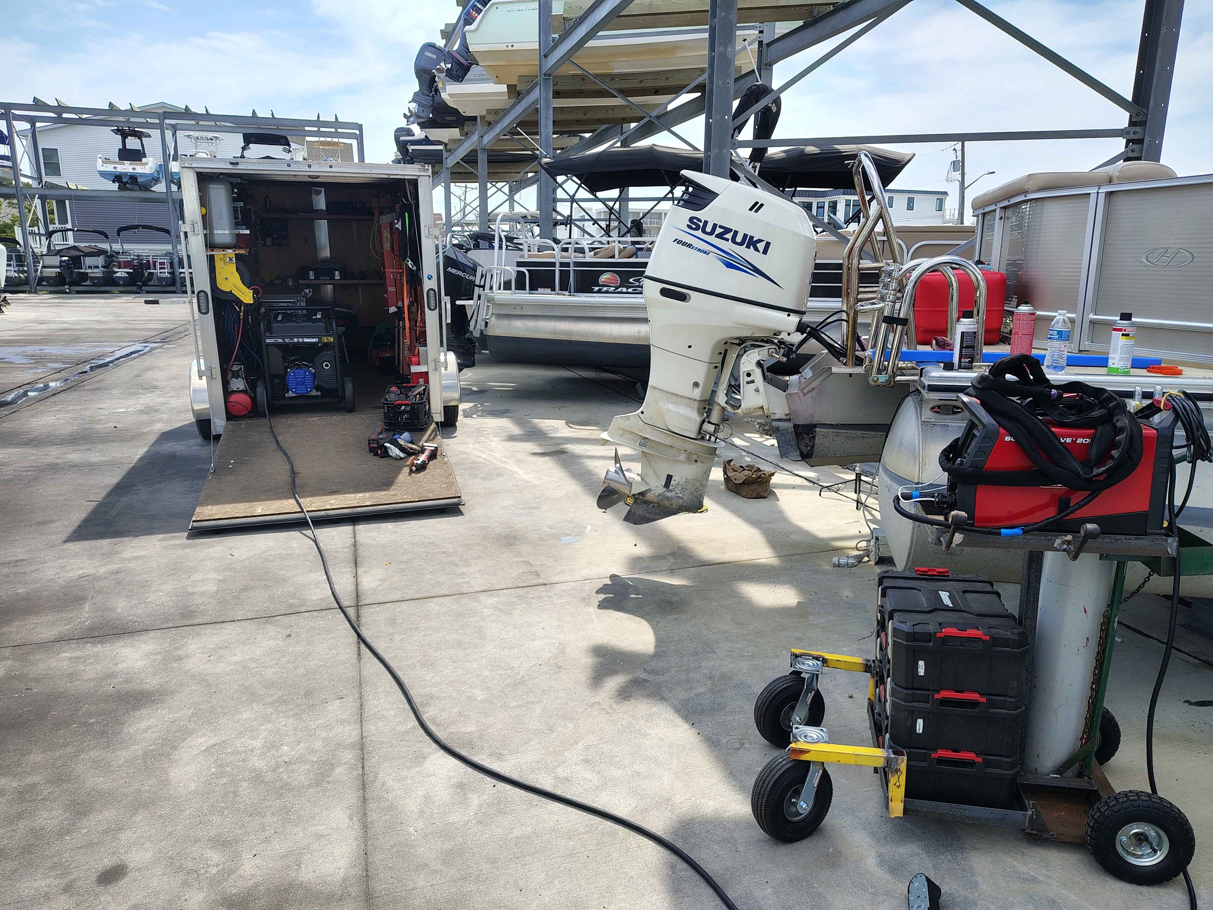 Mobile aluminum welding trailer set up at marina for boat transom repair in Rehoboth Beach Delaware