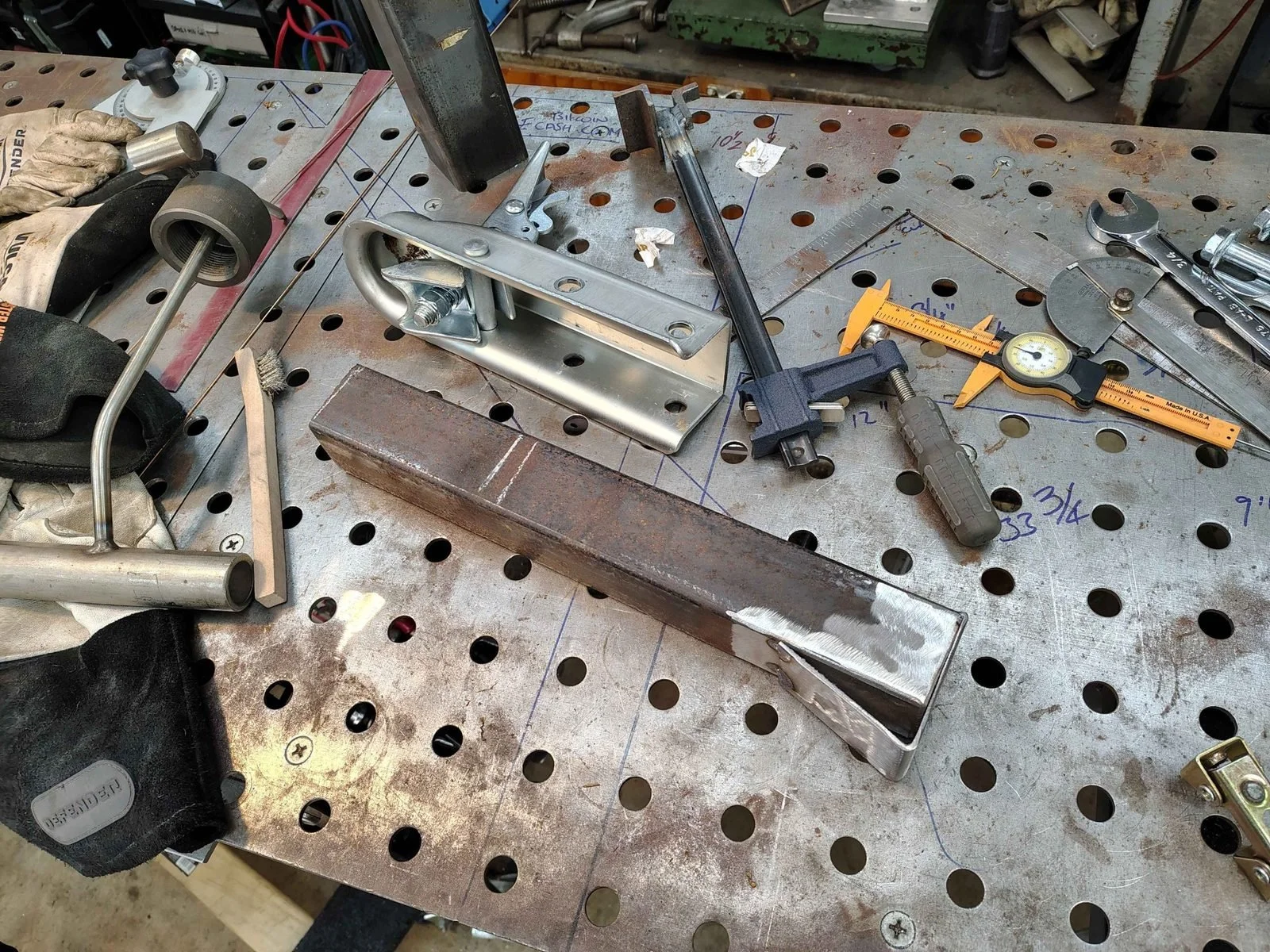 Fabricating a 2x3 to 2x2 steel tube transition from bent 1/8 inch plate next to the trailer coupler, by PIE Weld & Machine in the Chesapeake Bay region