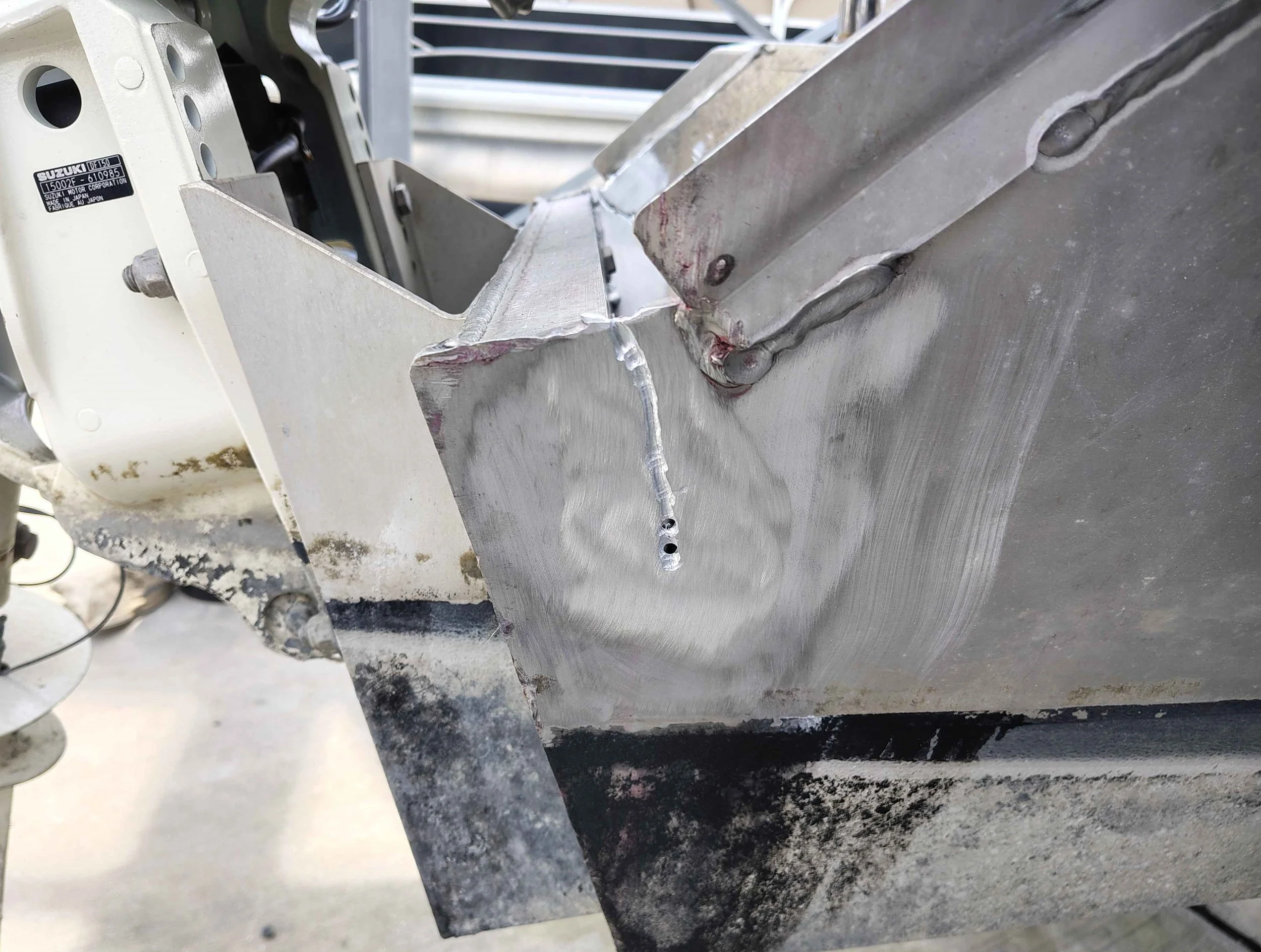 Ground out crack groove and stop drill holes on aluminum boat transom prepared for TIG welding