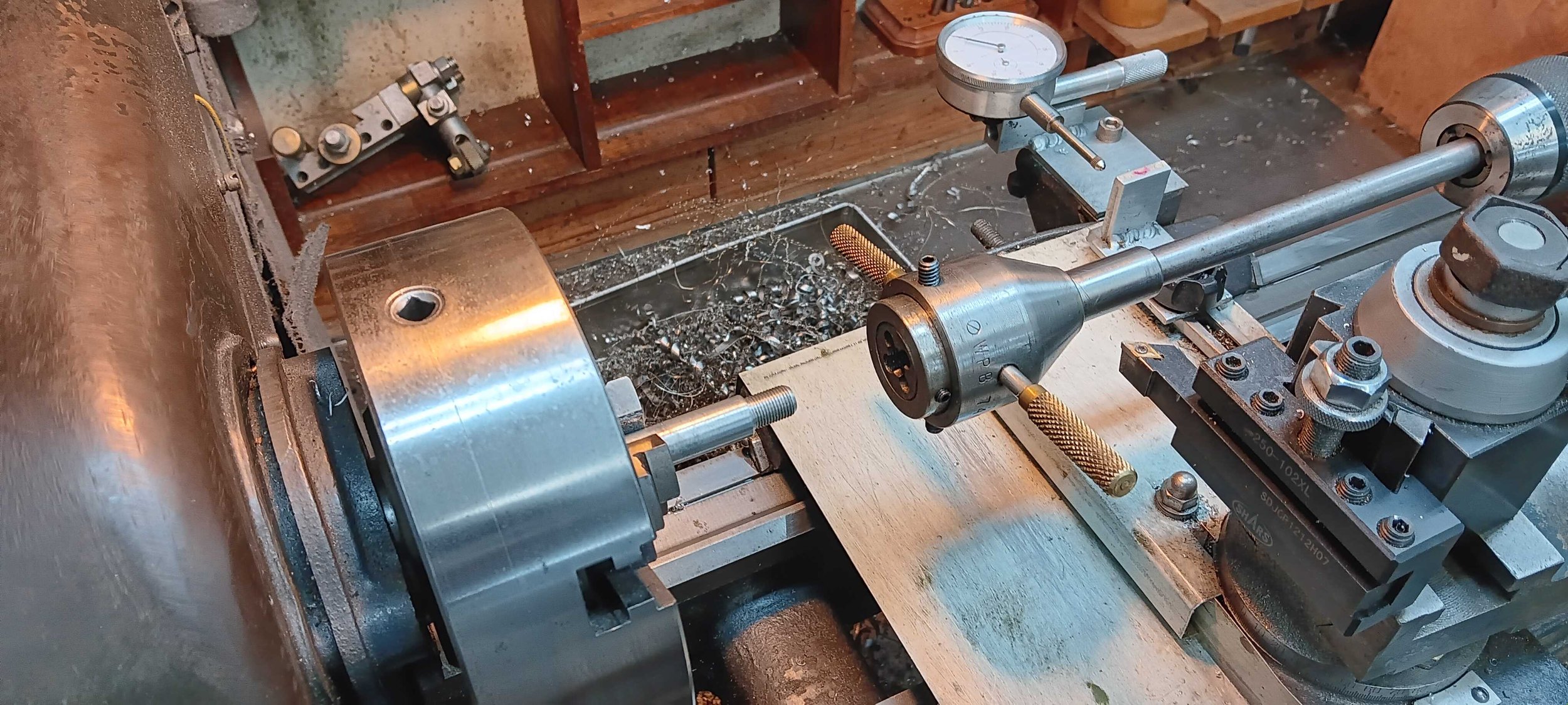 Aluminum rod threaded in a lathe chuck to make a custom plug for cast aluminum engine repair — machine shop and welding, PIE LLC Weld & Machine, Cecil County MD serving Maryland and Delaware