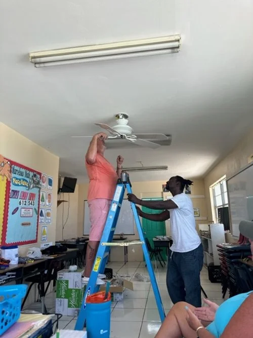 John Degross assisting in new ceiling fans