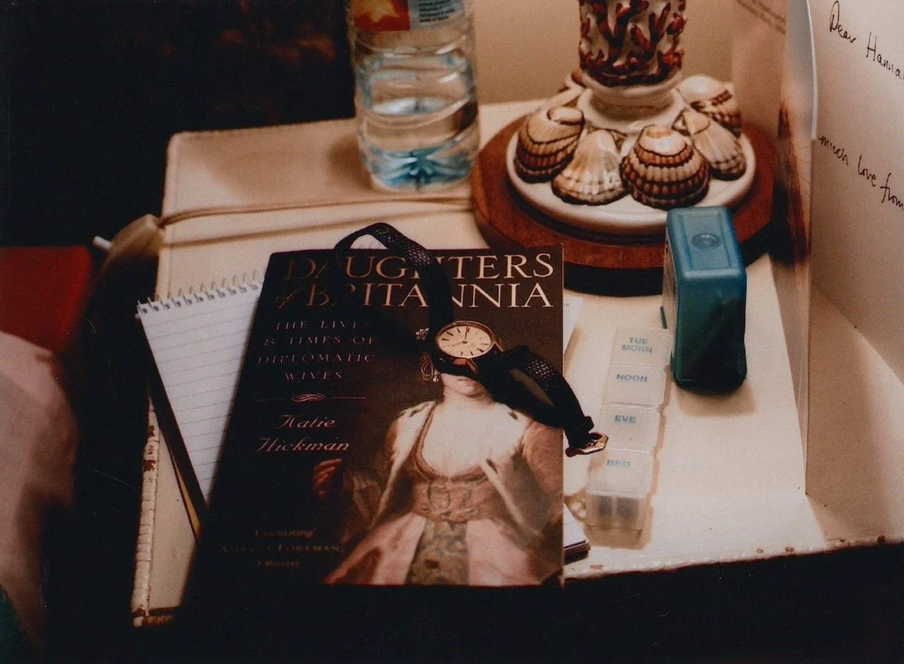 The book she was reading, her watch, an almost empty bottle of water, toothpicks, the pill box for the day, and a card - "Dear Hannah, Much love from . . . "