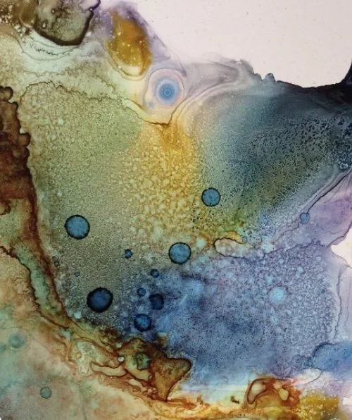 Abstract watercolor painting with shades of yellow, blue, purple, and green, featuring circular and fluid patterns.