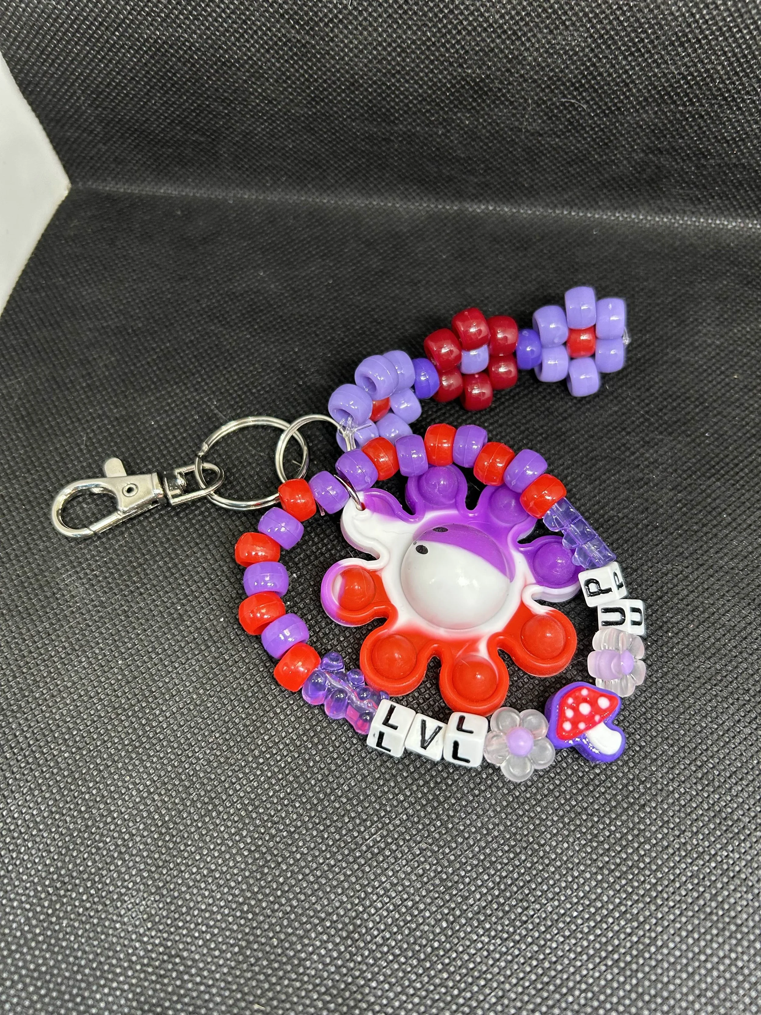 “LVL UP” Octopus Keychain | Red & Purple Beaded Gamer Accessory with Mushroom & Flower Charms