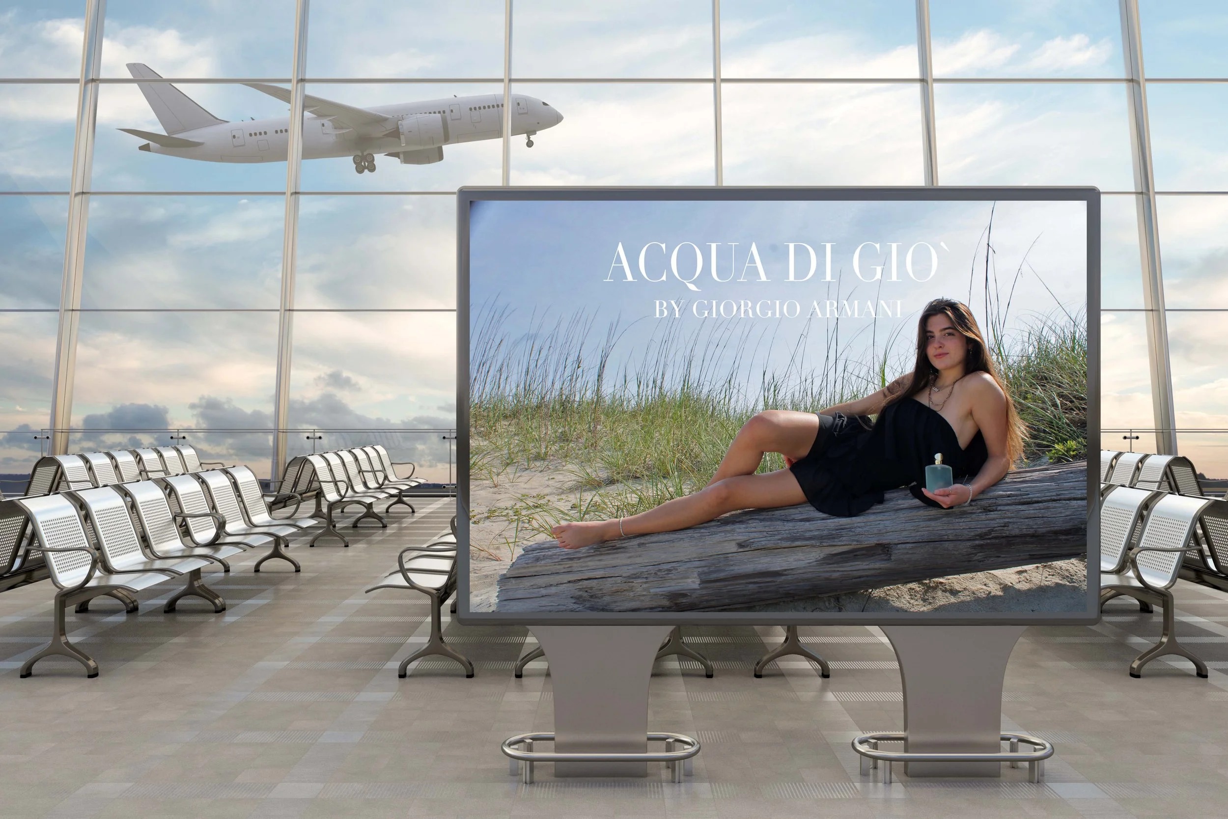 An airport waiting area with rows of empty seats, large windows showing a plane in the sky, and a digital display advertising 'Acqua di Giò' by Giorgio Armani featuring a woman in a black dress reclining on a log on a sandy beach.