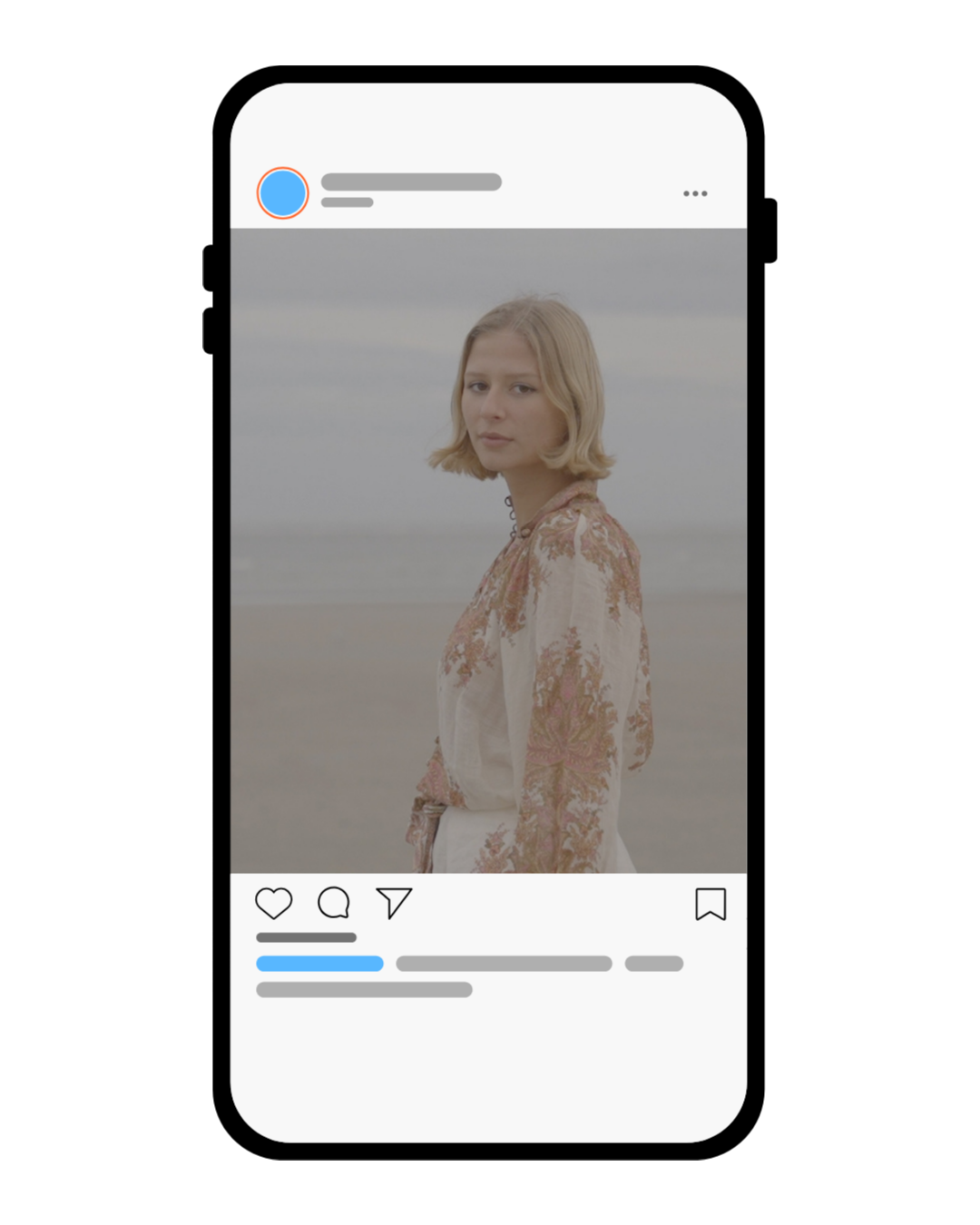 A young woman with blonde hair standing on a beach, wearing a floral patterned blouse, looking at the camera with a calm expression.