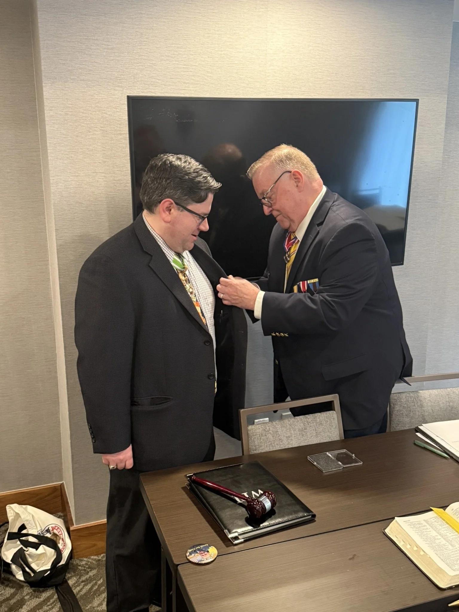 Commander in Chief Kevin Tucker pins the Department Commander badge on new Department Commander John Wilder