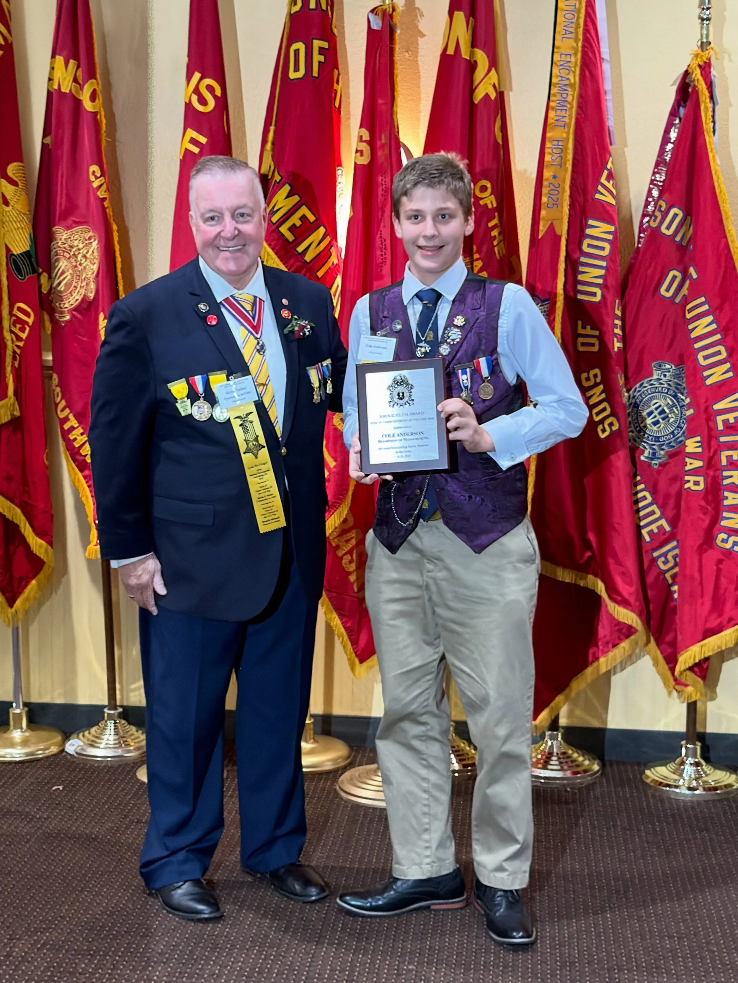 Brother Cole Anderson of the Department of Massachusetts is presented with an award as Most Outstanding Junior Member of the order by Commander in Chief Kevin Tucker.