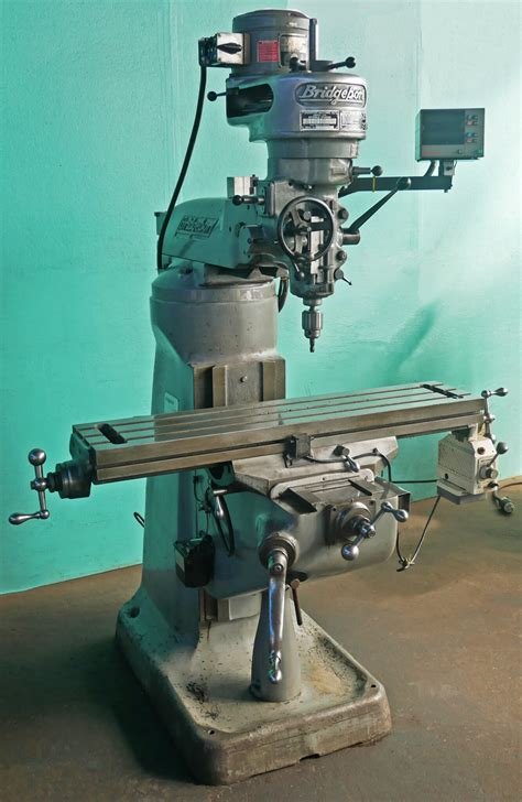 A standard manual bridgeport mill. A standard milling machine in front of a green screen.