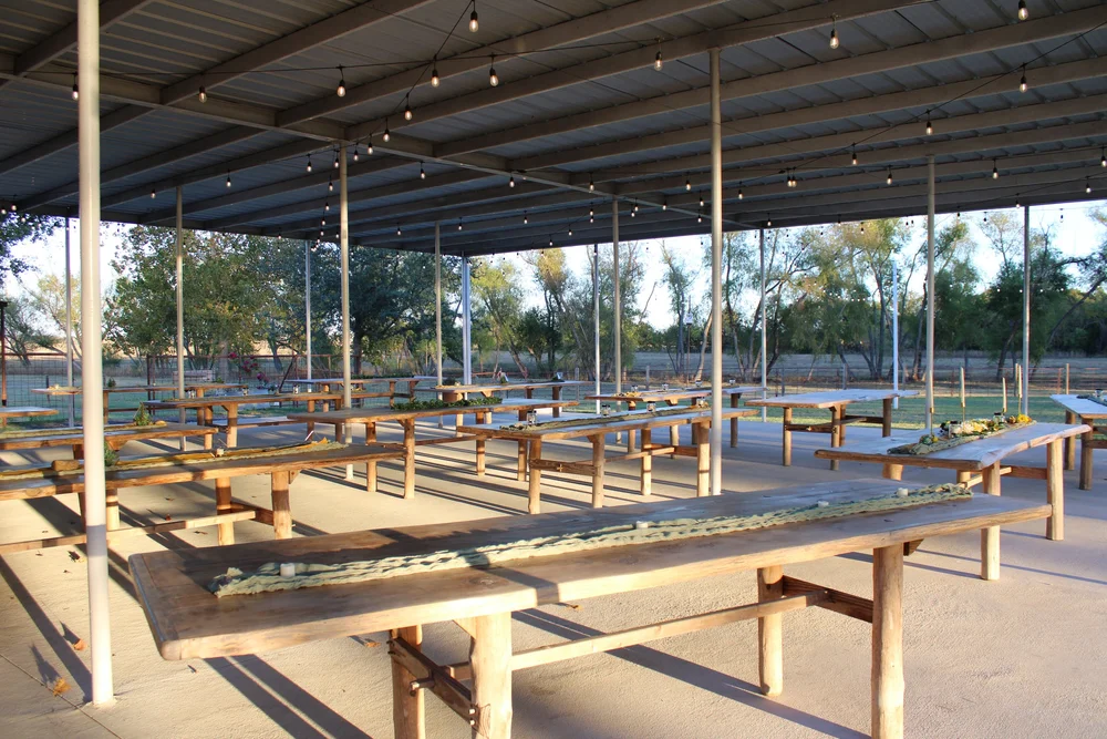 The open-air reception pavilion set for a gathering
