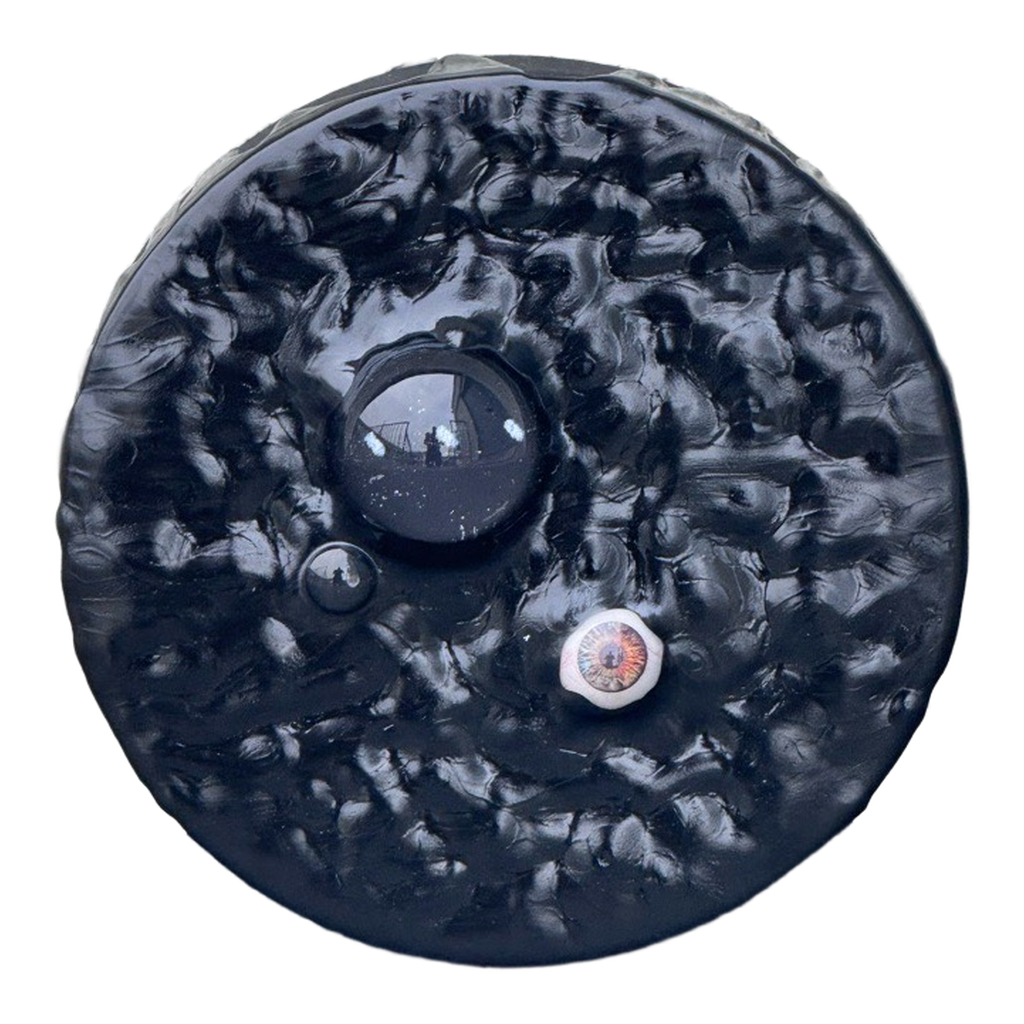 Boiling Point: Ellipses, 2026. Glass domes, prosthetic glass eye, and acrylic on panel. 6 inches diameter