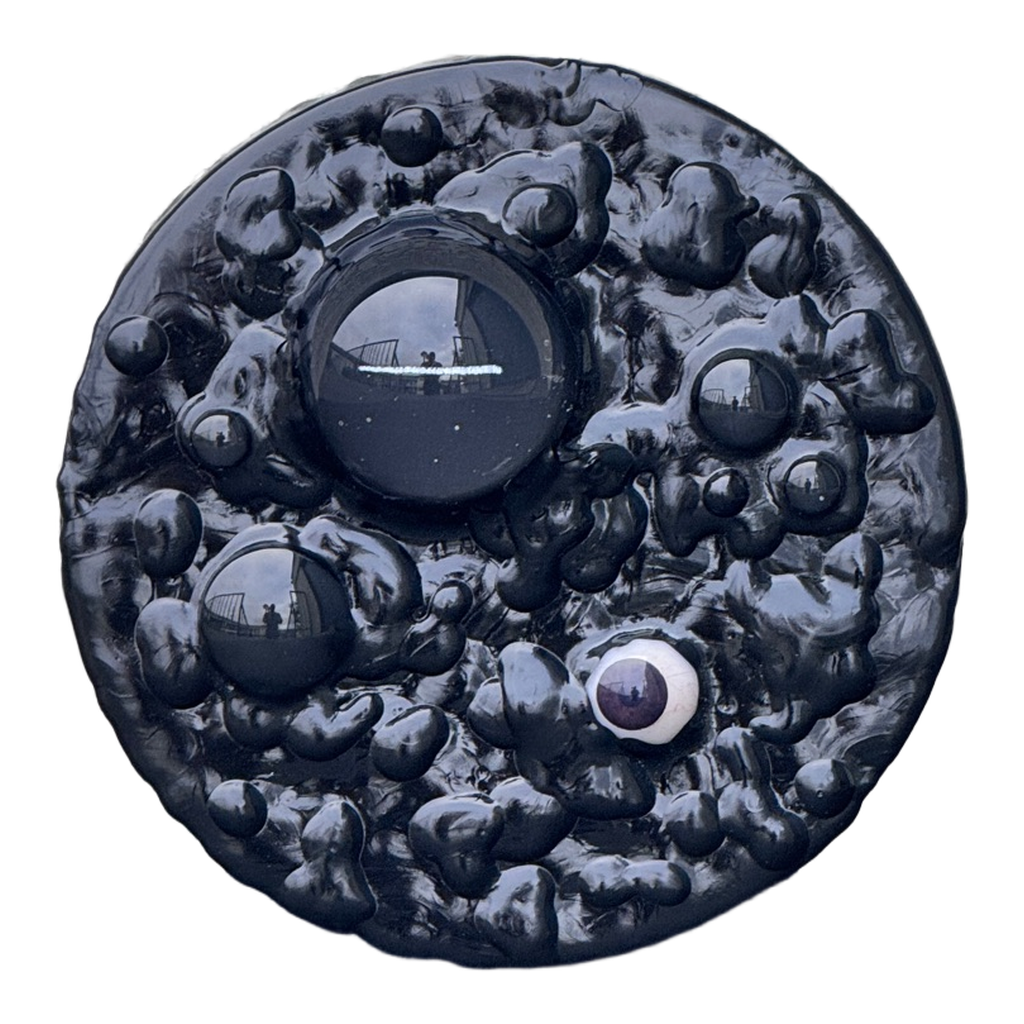 Boiling Point: Em Dash, 2026. Glass domes, prosthetic glass eye, and  acrylic on panel. 6 inches diameter 