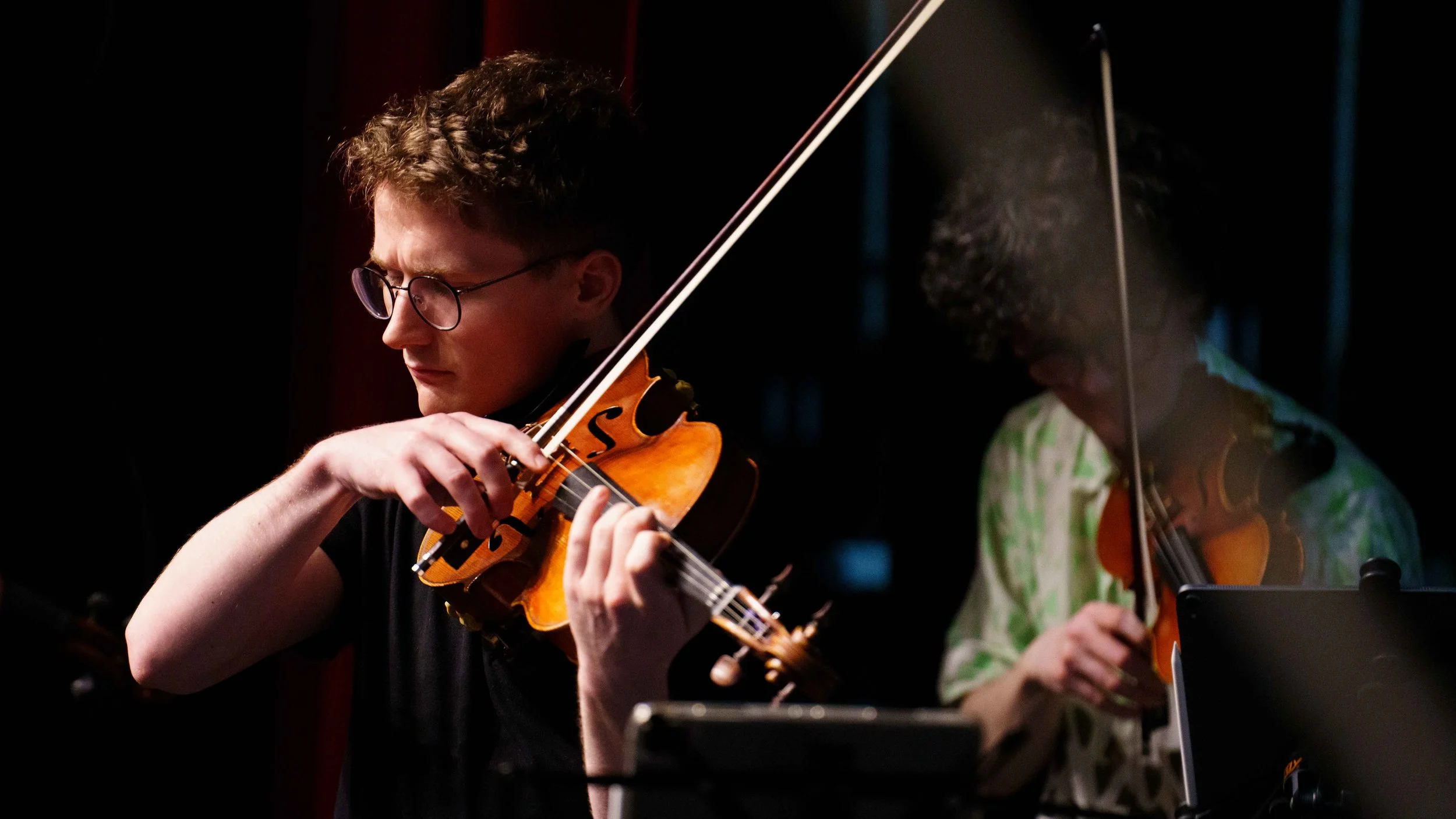  Violist Chris Broyles and violinist Evan Hjort rehearse Bach's Brandenburg concerto No. 3. 