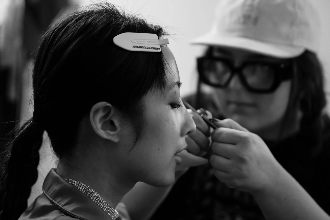  Elise (R) curls Su’s lashes.  